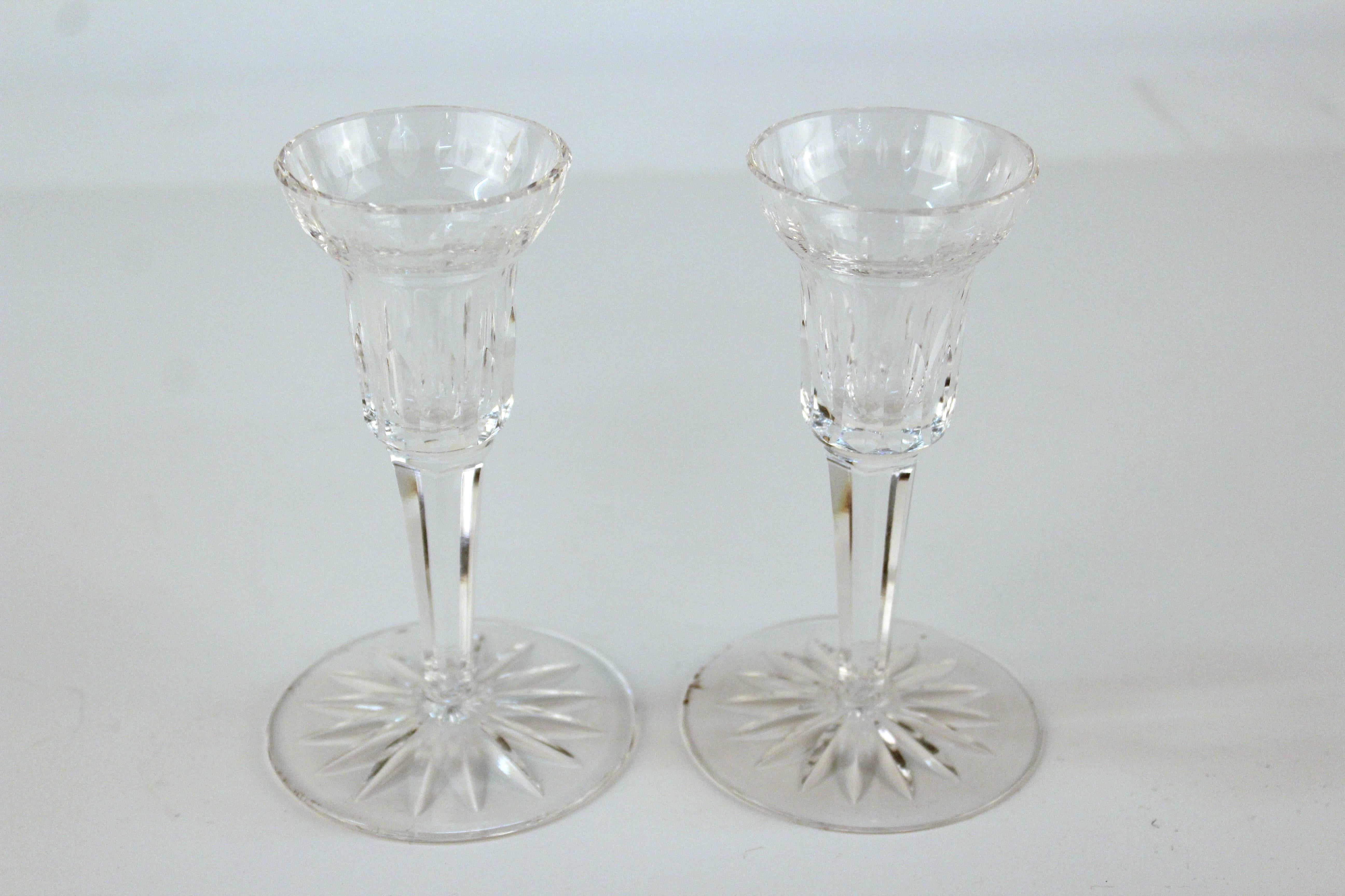 Pair of clear cut crystal candlesticks marked [Waterford] on the base. Each dates from the twentieth century and is in good vintage condition having wear consistent with age and use.

 