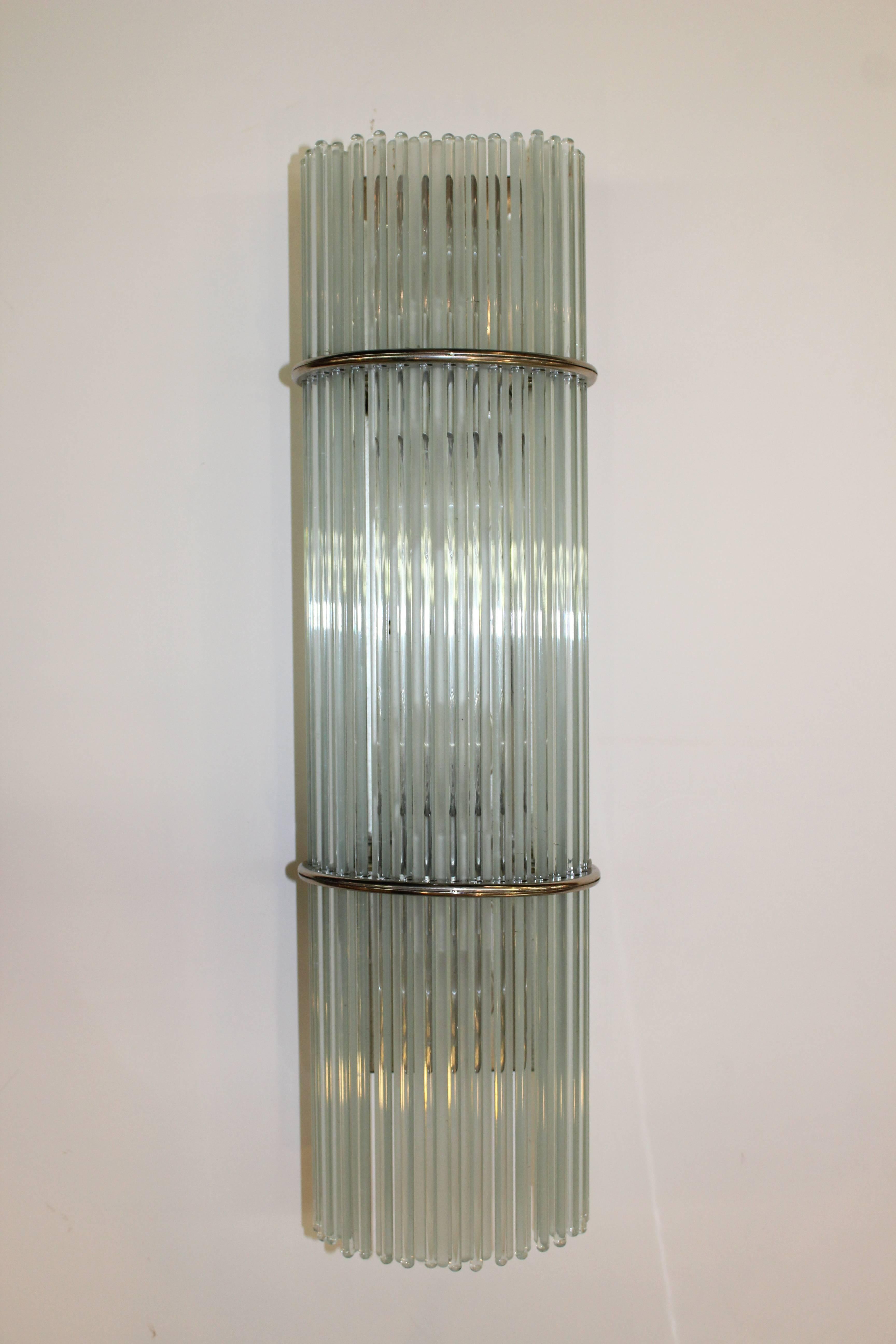 A pair of Italian Mid-century Modern glass sconces by Gaetano Sciolari. Crafted using many small rods of glass supported by nickel-plated backs. 
110634
  