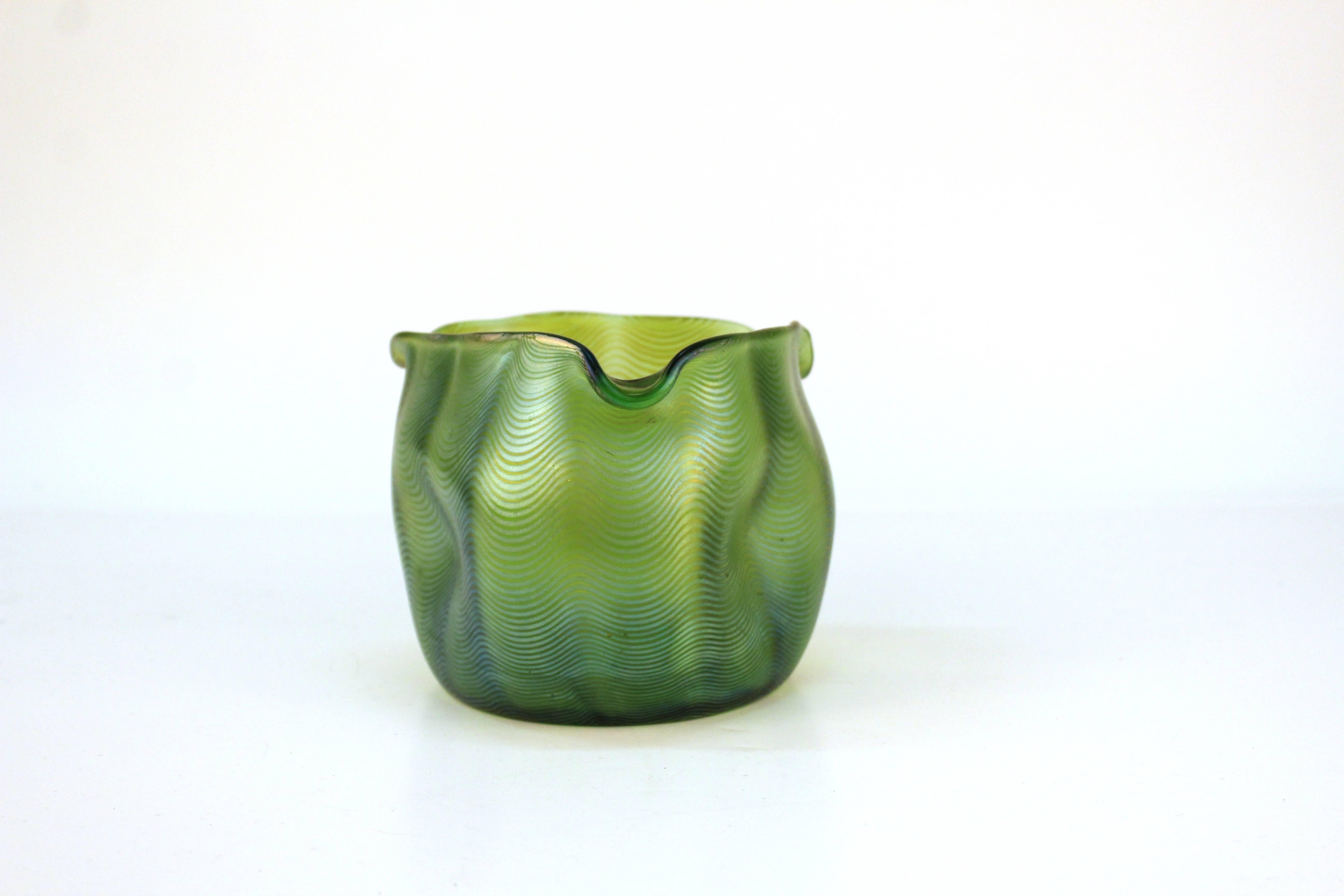 A turn of the century vessel by Lutz, produced in a stunning shade of iridescent green.

110613

 