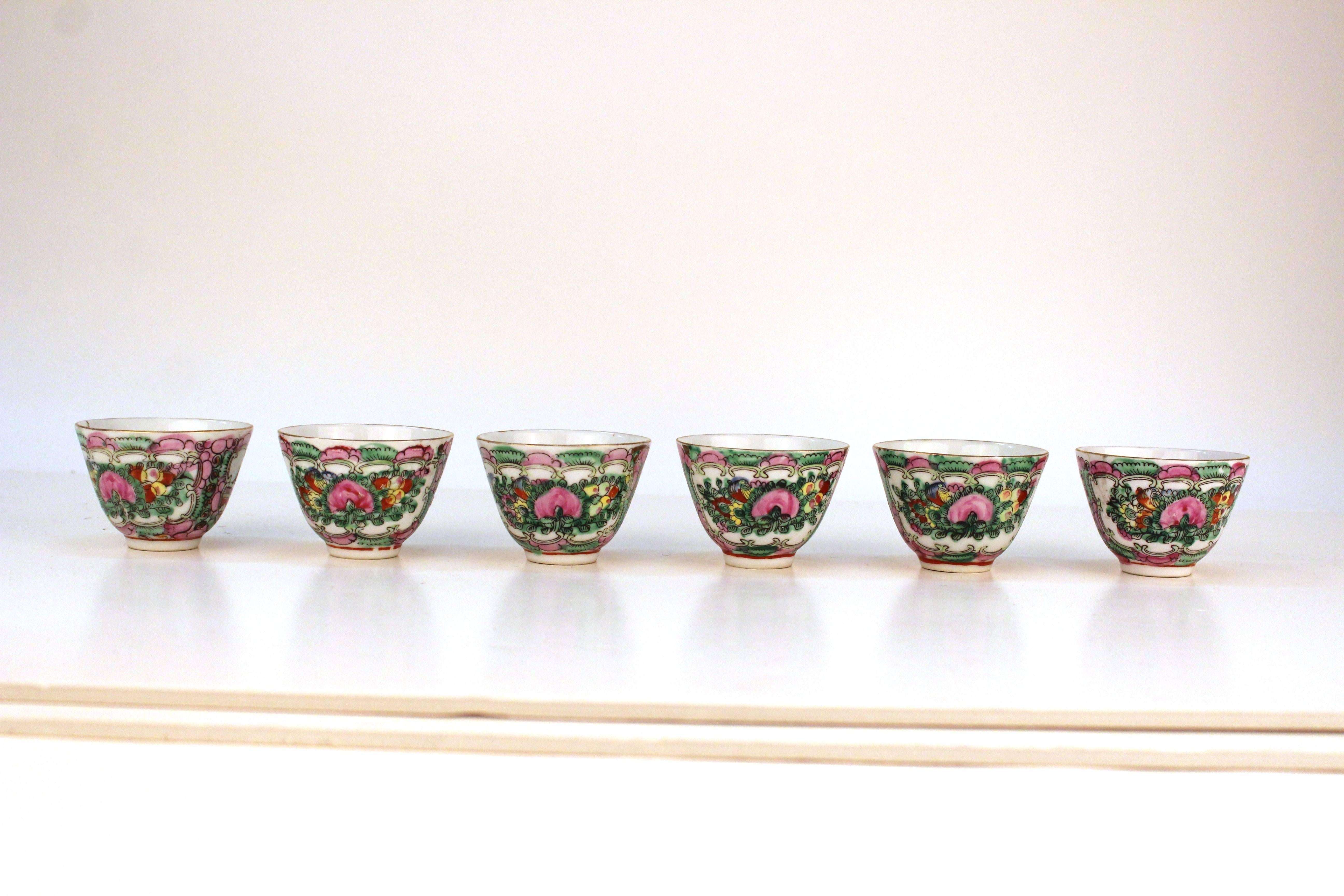 Set of six Asian porcelain cups. Each with an elaborate floral design and lovers scene in bright hues of pink, orange and green. In overall good condition with wear appropriate to age and use. Matching plates available. 

110617


          