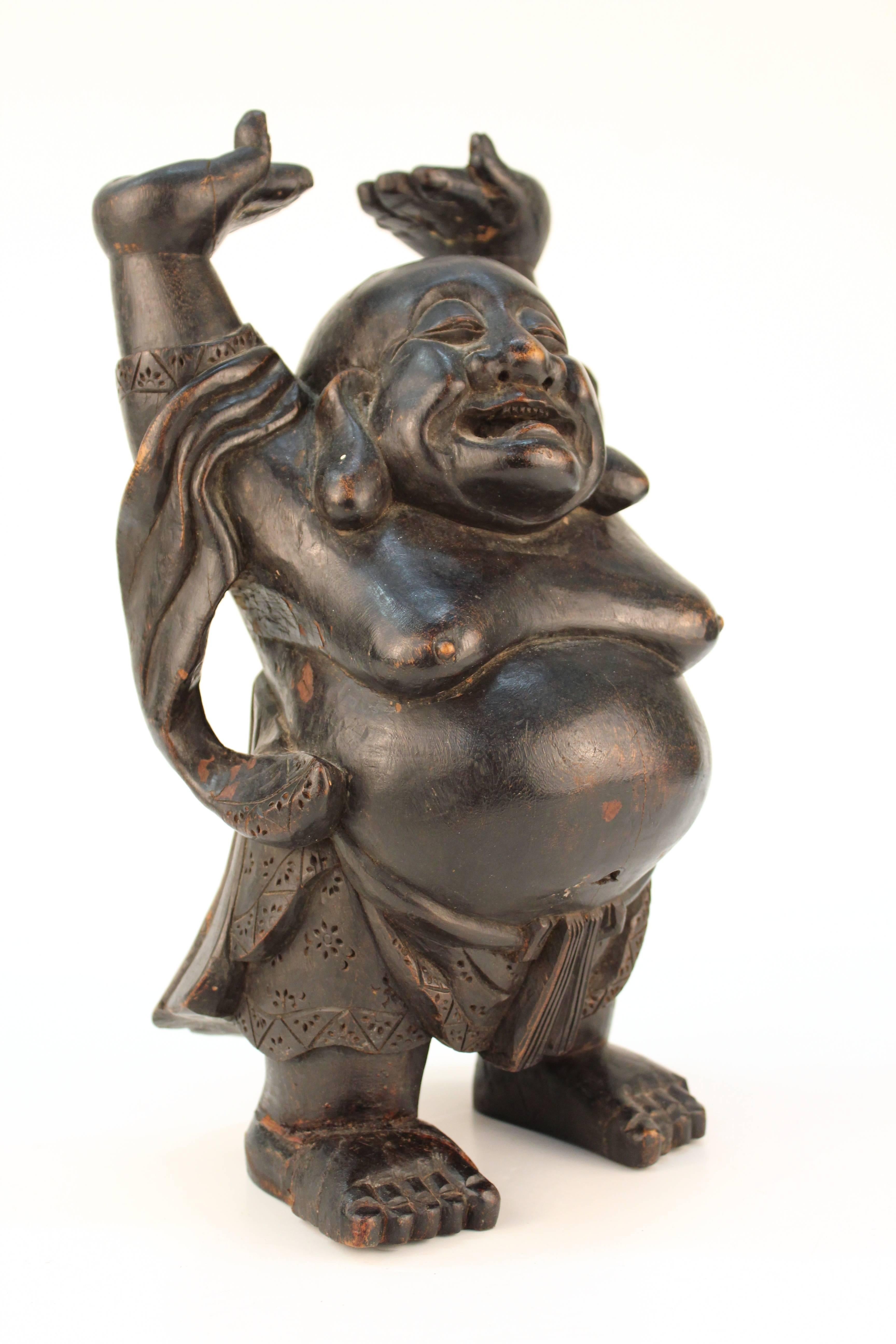 A large wooden carving of the laughing Buddha, Ho Tai. Crafted in China. Despite some age appropriate wear to the wood, the sculpture remains in overall good vintage condition.

110622
 