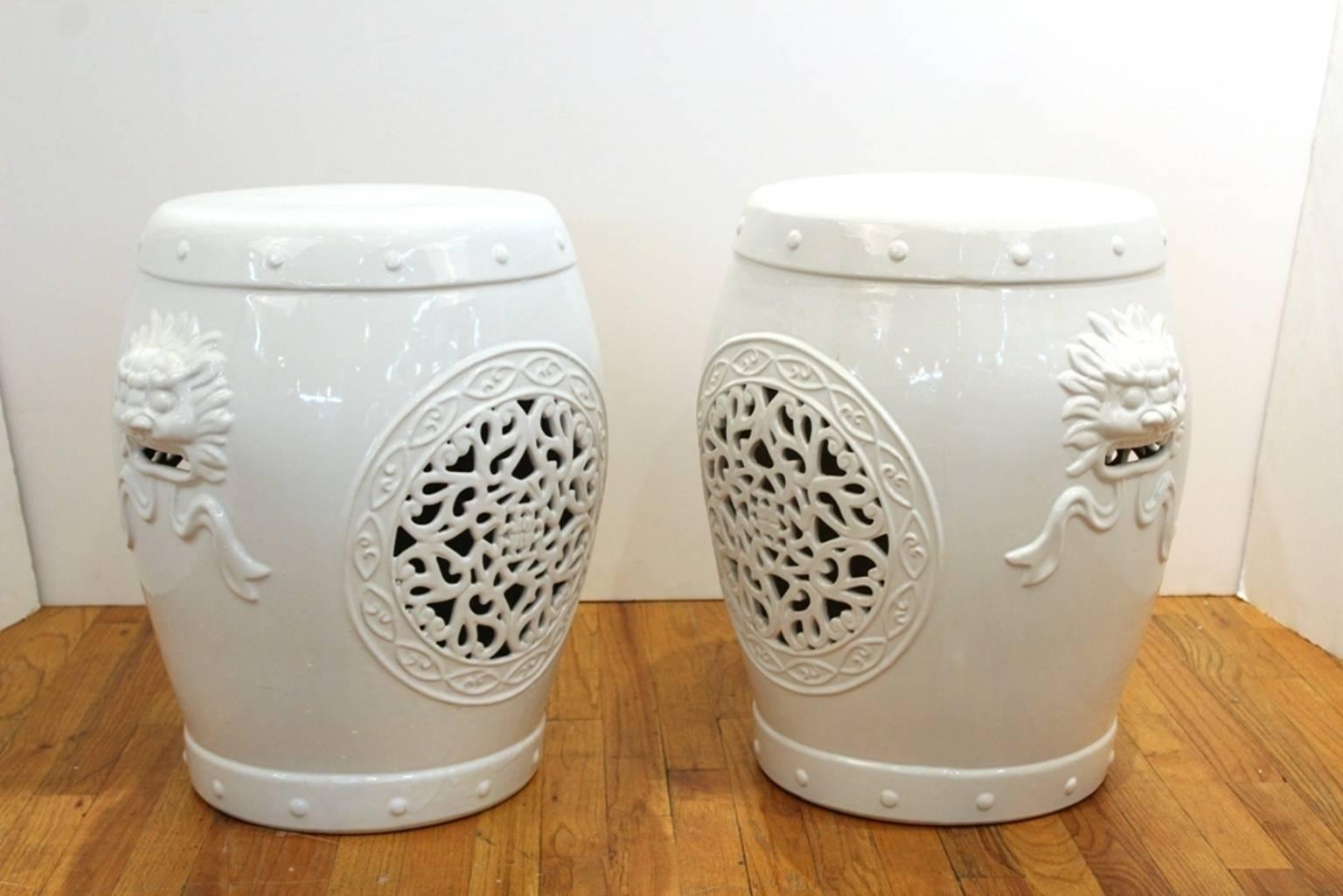 Garden stool in white glazed ceramic. Decorated with cut out patterns, medallions and lions similar to Asian motifs. Marked [GUMPS San Francisco] on the underside. Minor wear due to age and use but in overall good condition. Only a single stool is