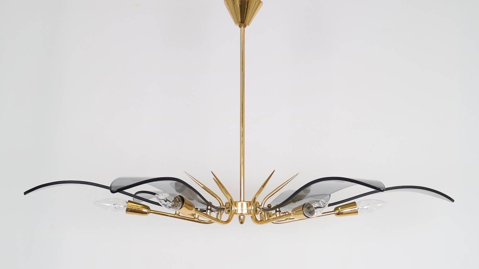 A chandelier with curved smoked glass panels in a radial layout affixed to an electroplated gold metal body. In perfect vintage condition. This chandelier uses six candelabra E-14 bulbs. 

110761