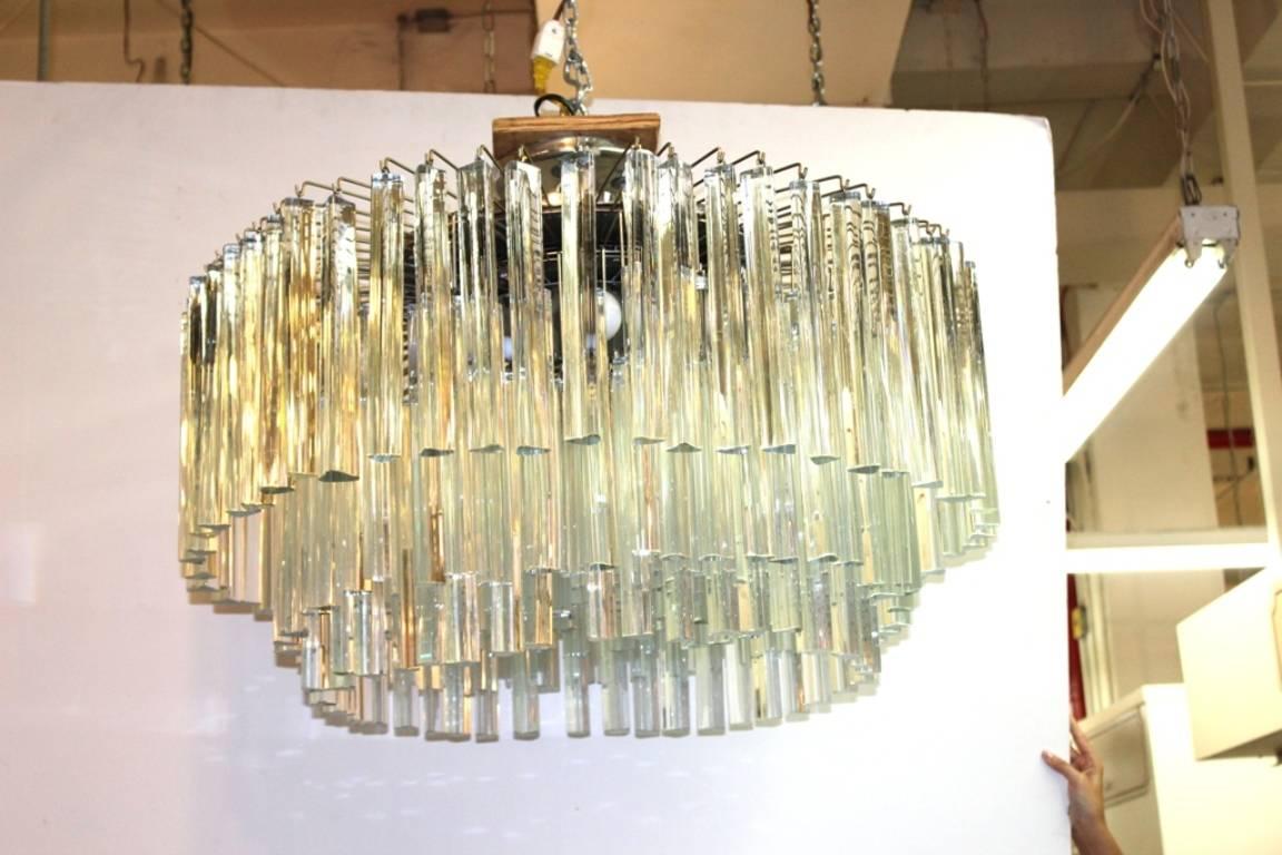 This monumental Venini chandelier is multi-tiered and features triangular shaped glass pieces.