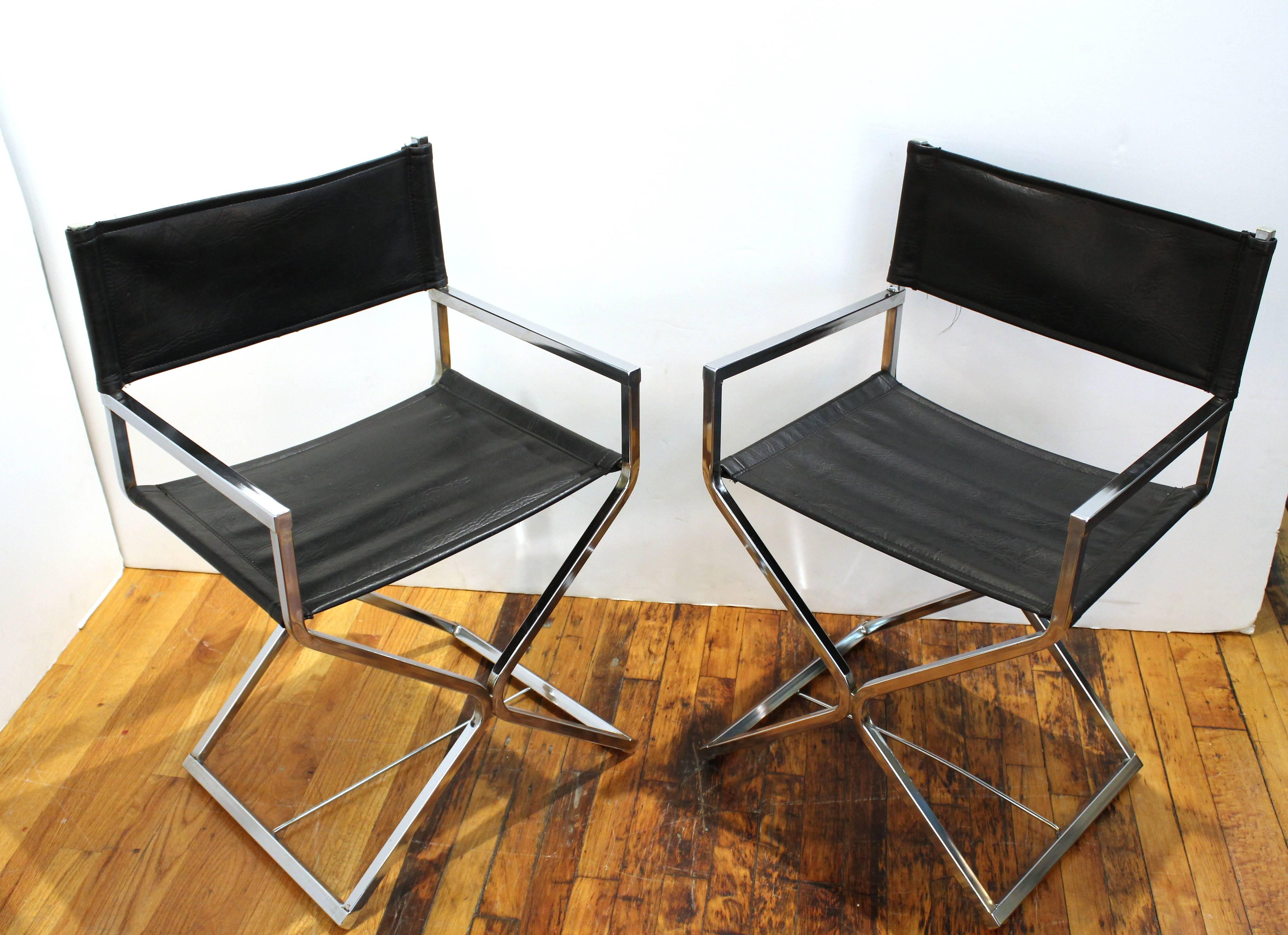 A pair of directors chairs styled in soft black leather and shiny chrome.