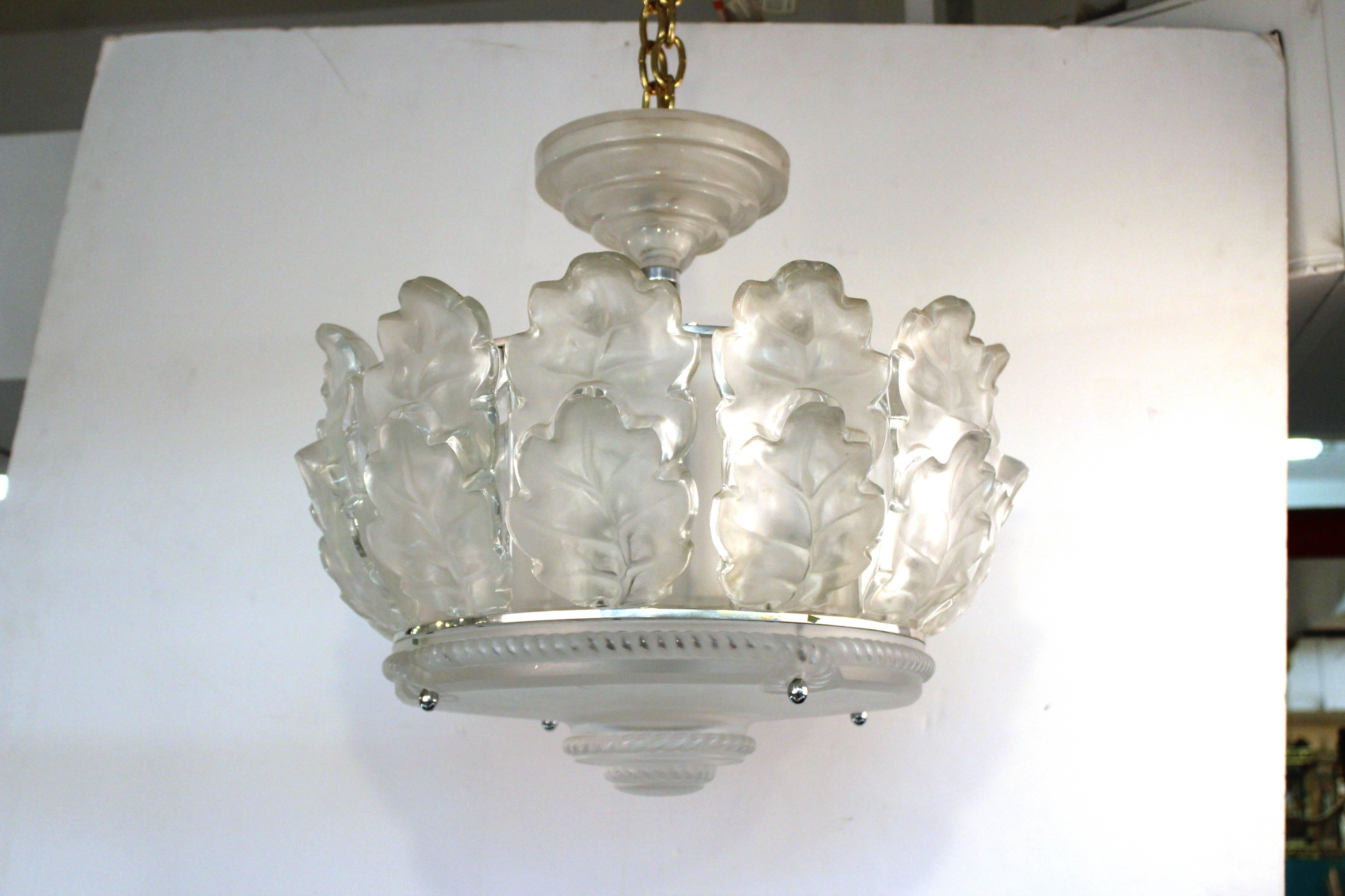 Chandelier by Lalique from the "Chene" collection which features two tiers of frosted glass oak leaves.
