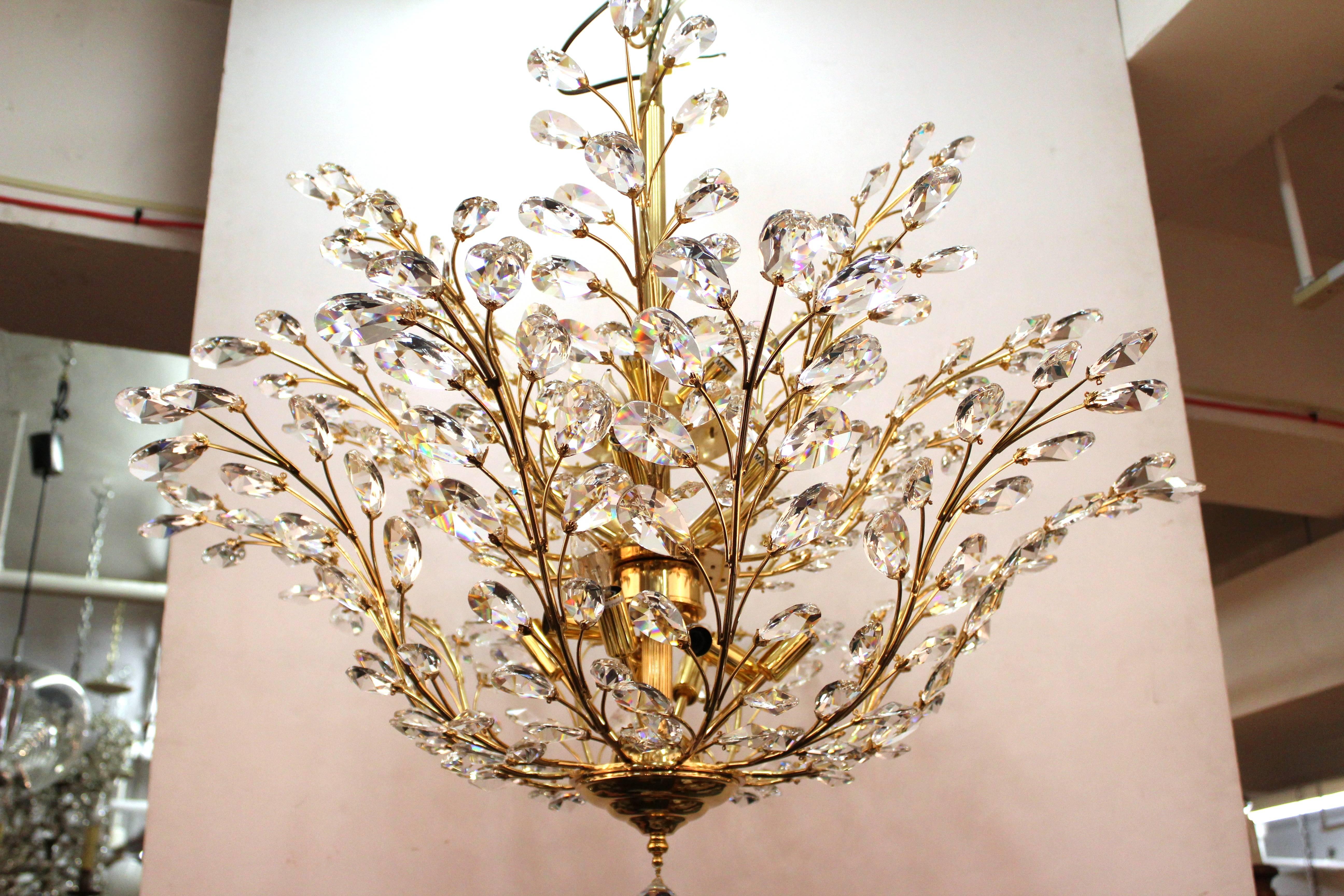 Mid-century 1950s Italian 24k gold plated brass and Swarovski  crystal chandelier. Rewired to US standard. Accepts 16 candelabra base bulbs. Two available for purchase. 
