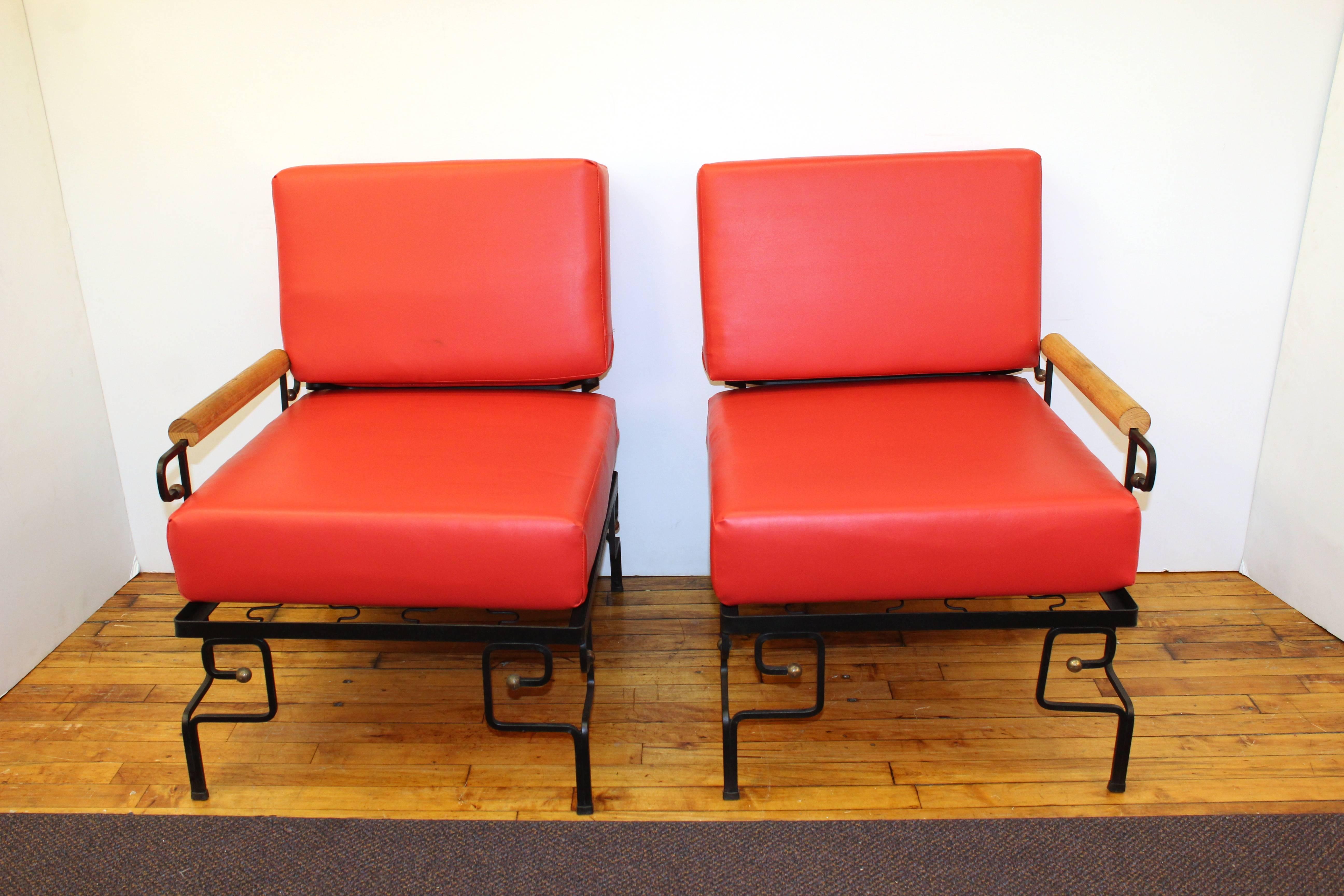 This Mid-Century Modern loveseat set by Wroughtan for Ritts is made out of iron and wood with red upholstery. The loveseat can be separated into two separate, free-standing chairs. There is some gold paint detailing to the iron base. In good vintage