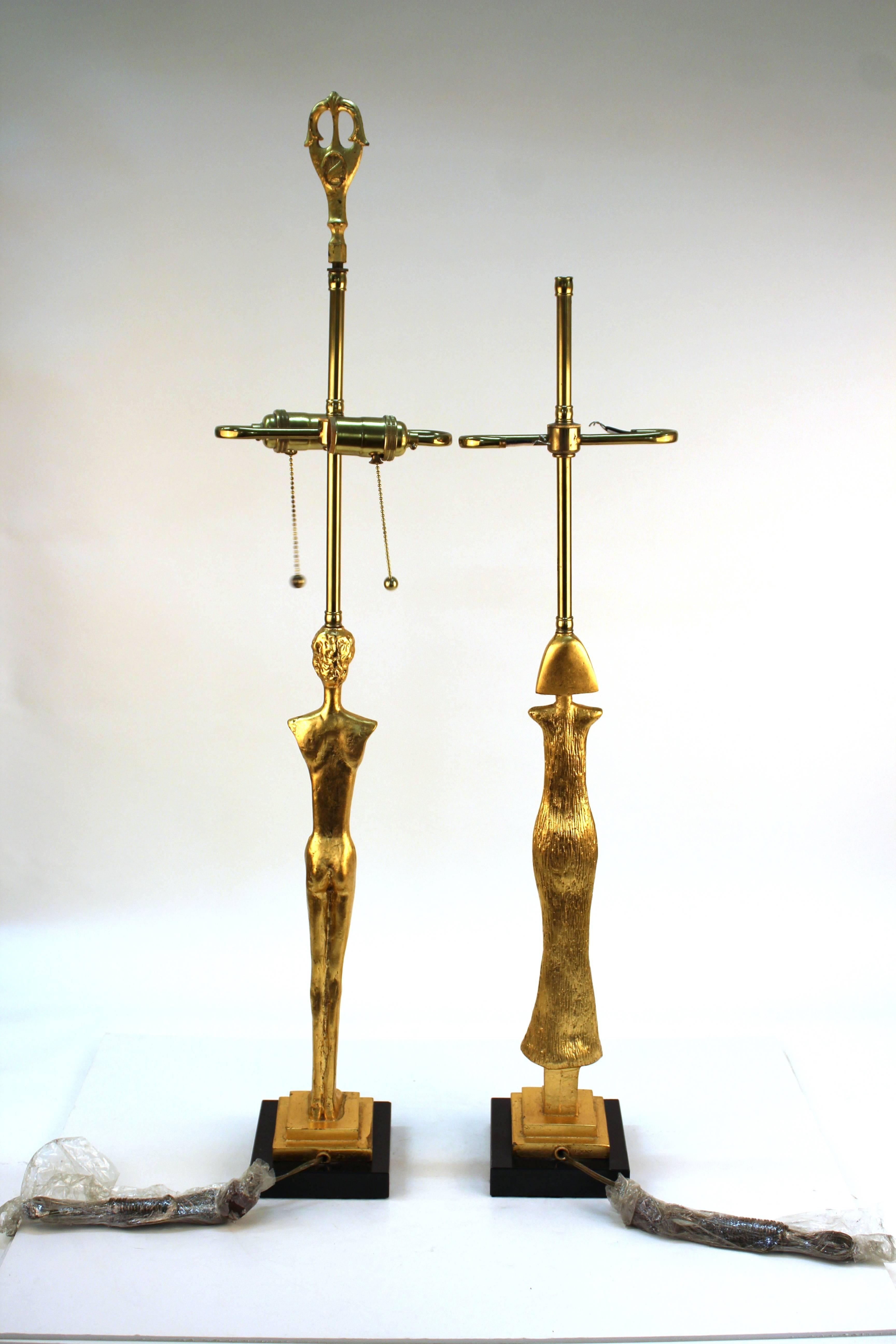 Pair of gold-tone table lamps after Giacometti in the form of a stylized man and woman.