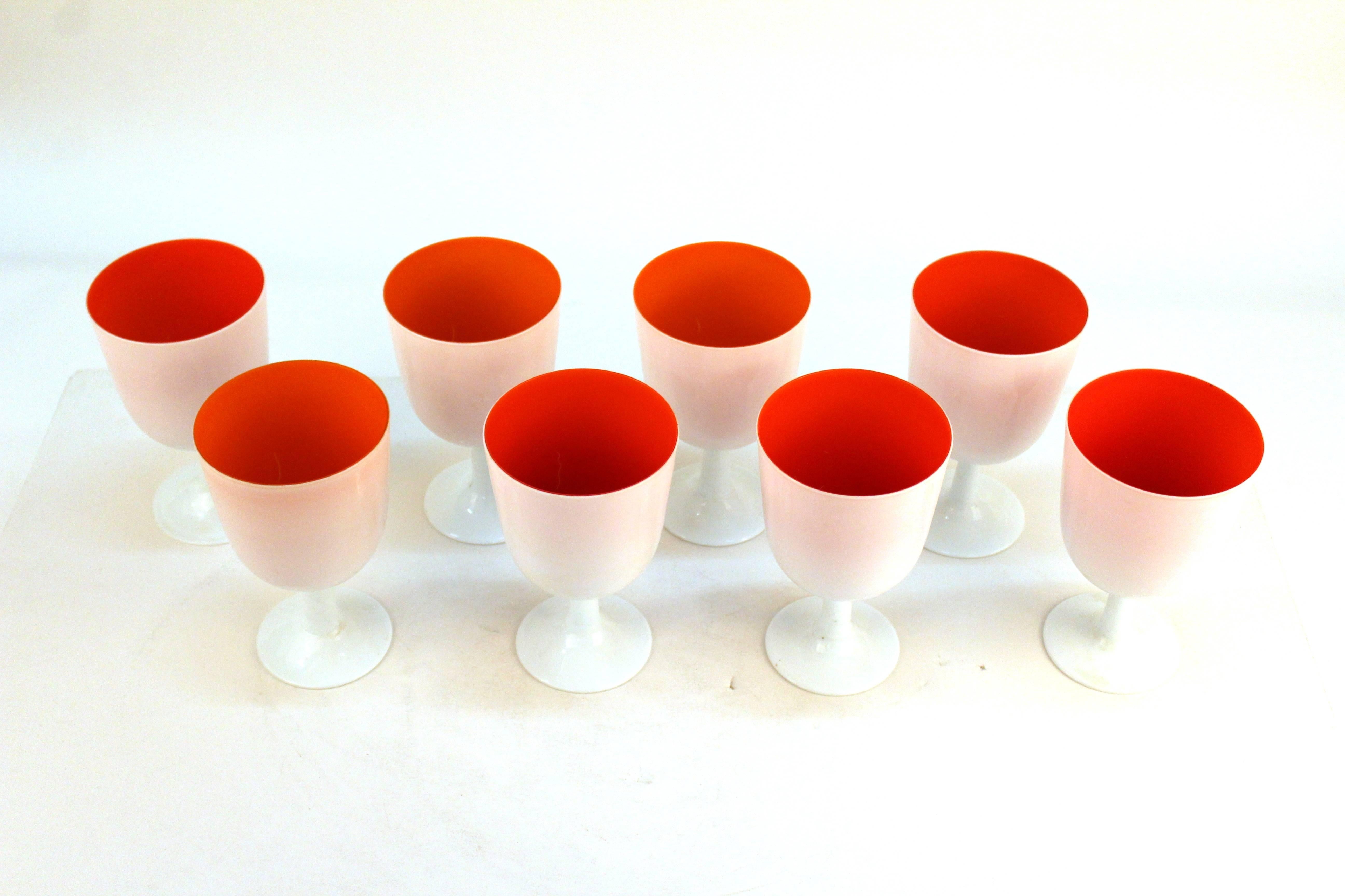 Set of six water goblets by Carlo Moretti with white exterior and bright orange interior. Matching luncheon and serving plates also available.110930.