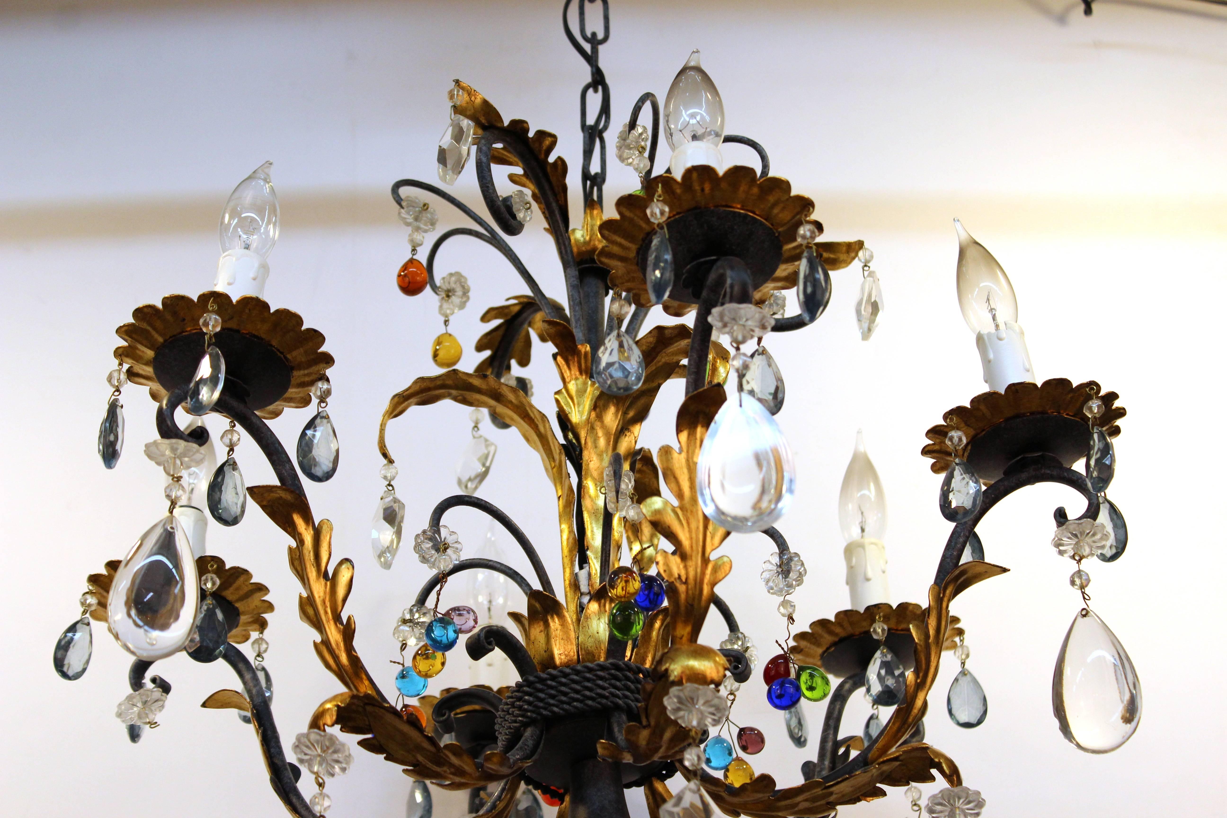 A chandelier with multicolored jewel toned glass drops in gilt tole wheat sheaf form.