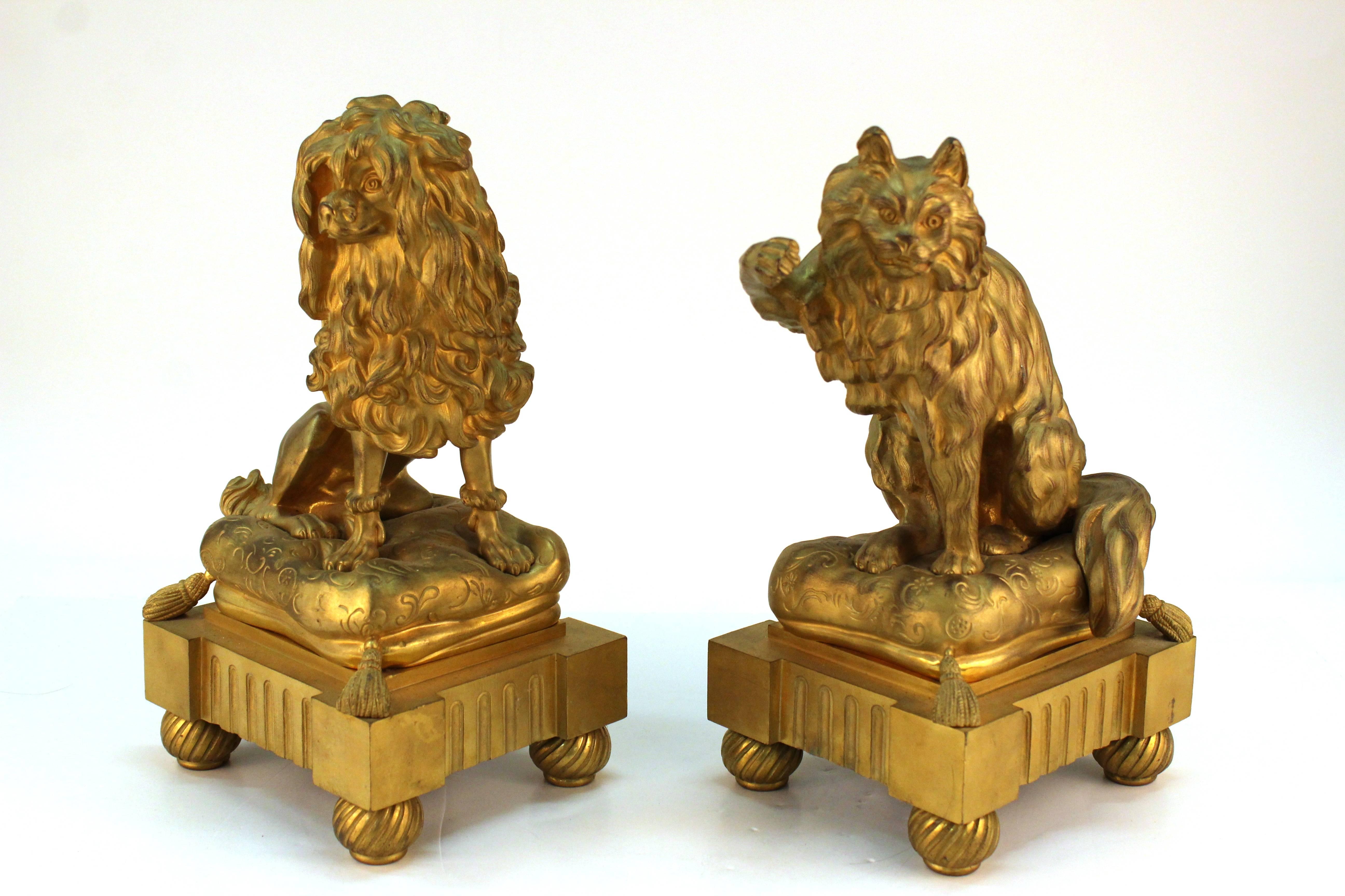 A pair of fireplace chenets after Caffieri in the form a pampered pooch and playful kitten atop luxurious cushions, produced in gold-tone bronze. 

Dog: 12