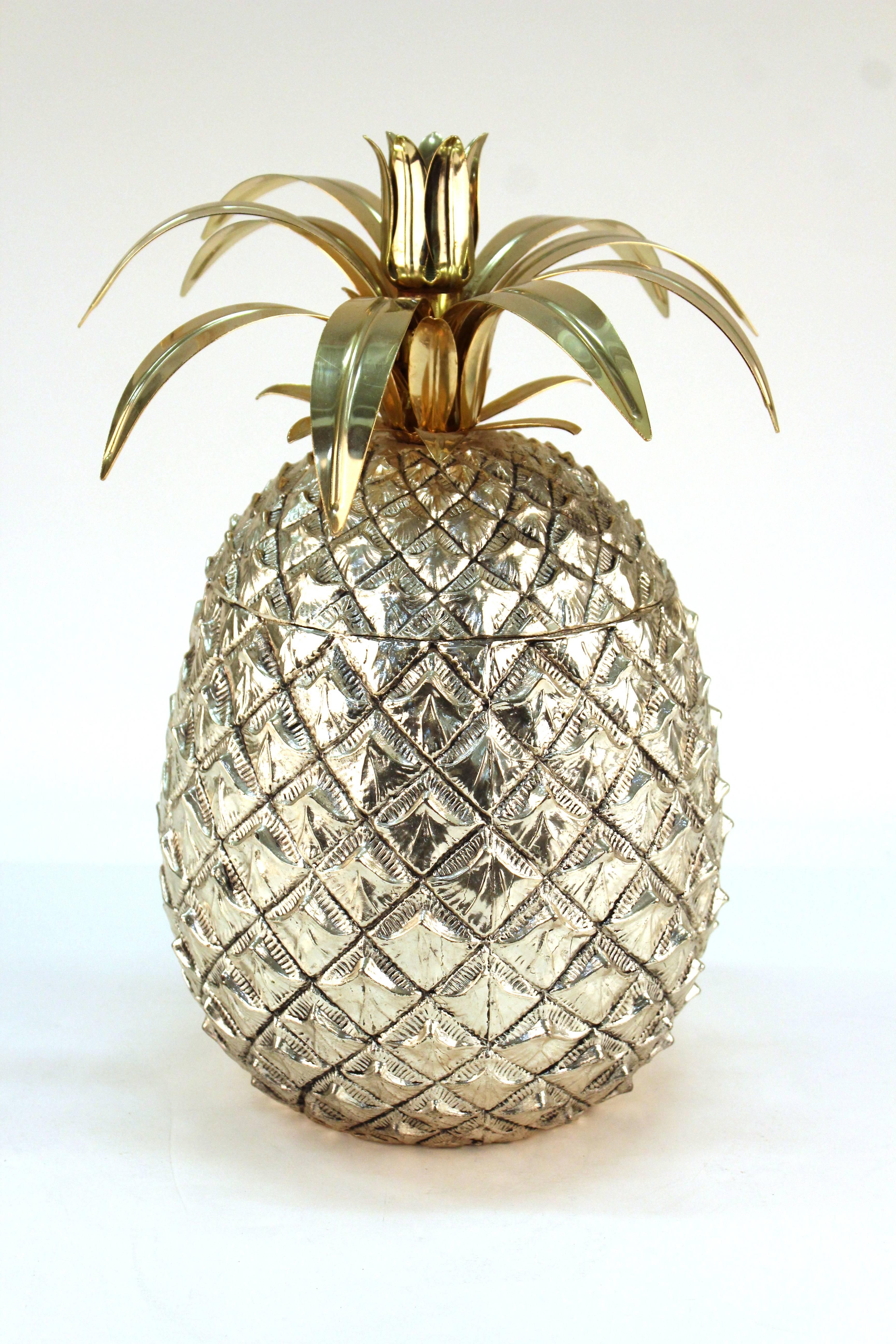 An ice bucket by Mauro Manetti in the shape of a large pineapple with a chrome colored body and a lid with gold-tone stem. Includes an insulated interior. In very good vintage condition.