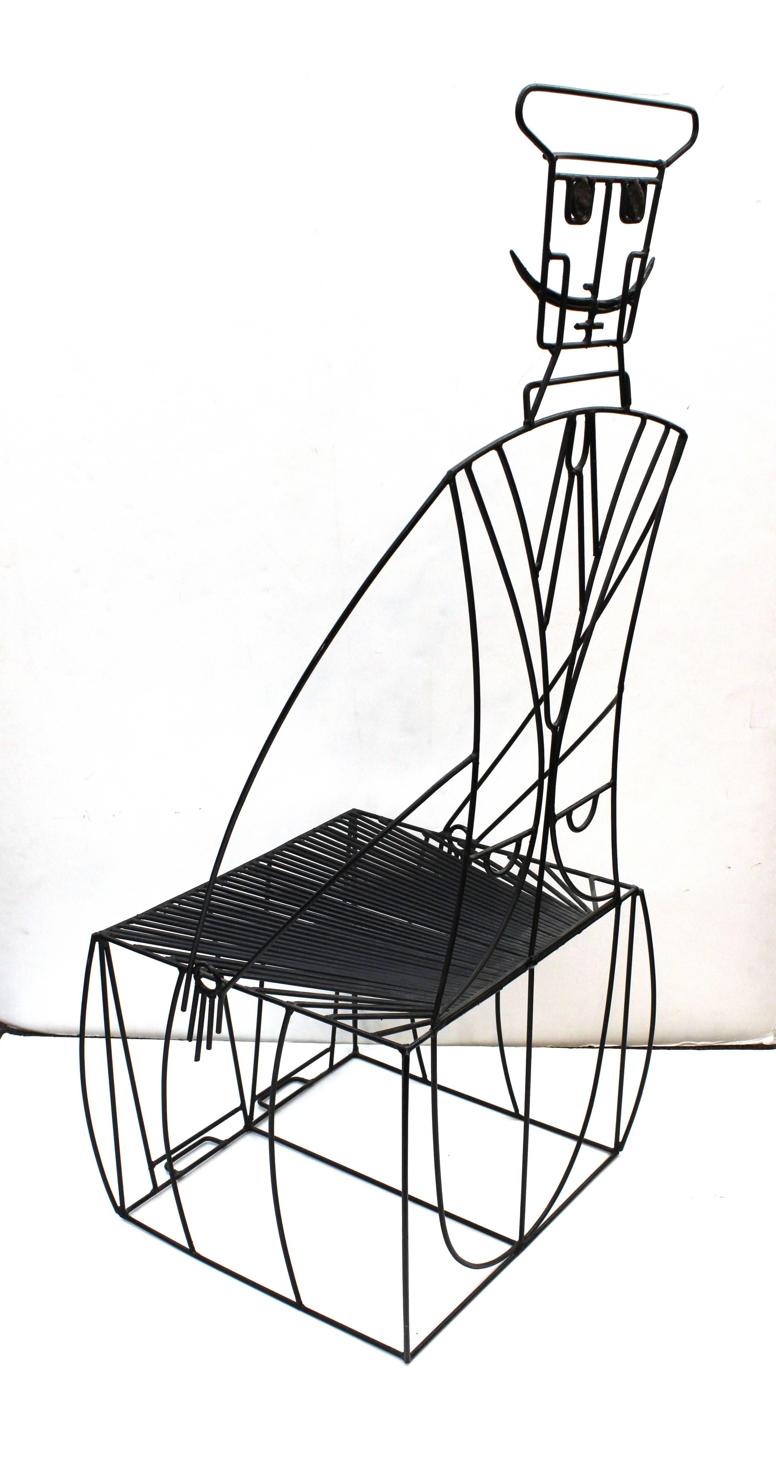 A whimsical chair in the form of a seated man wearing a suit and hat sporting a mustache by John Risley. The chair is entirely in black wrought iron with the man's arms forming the arms of the chair. In very good condition.