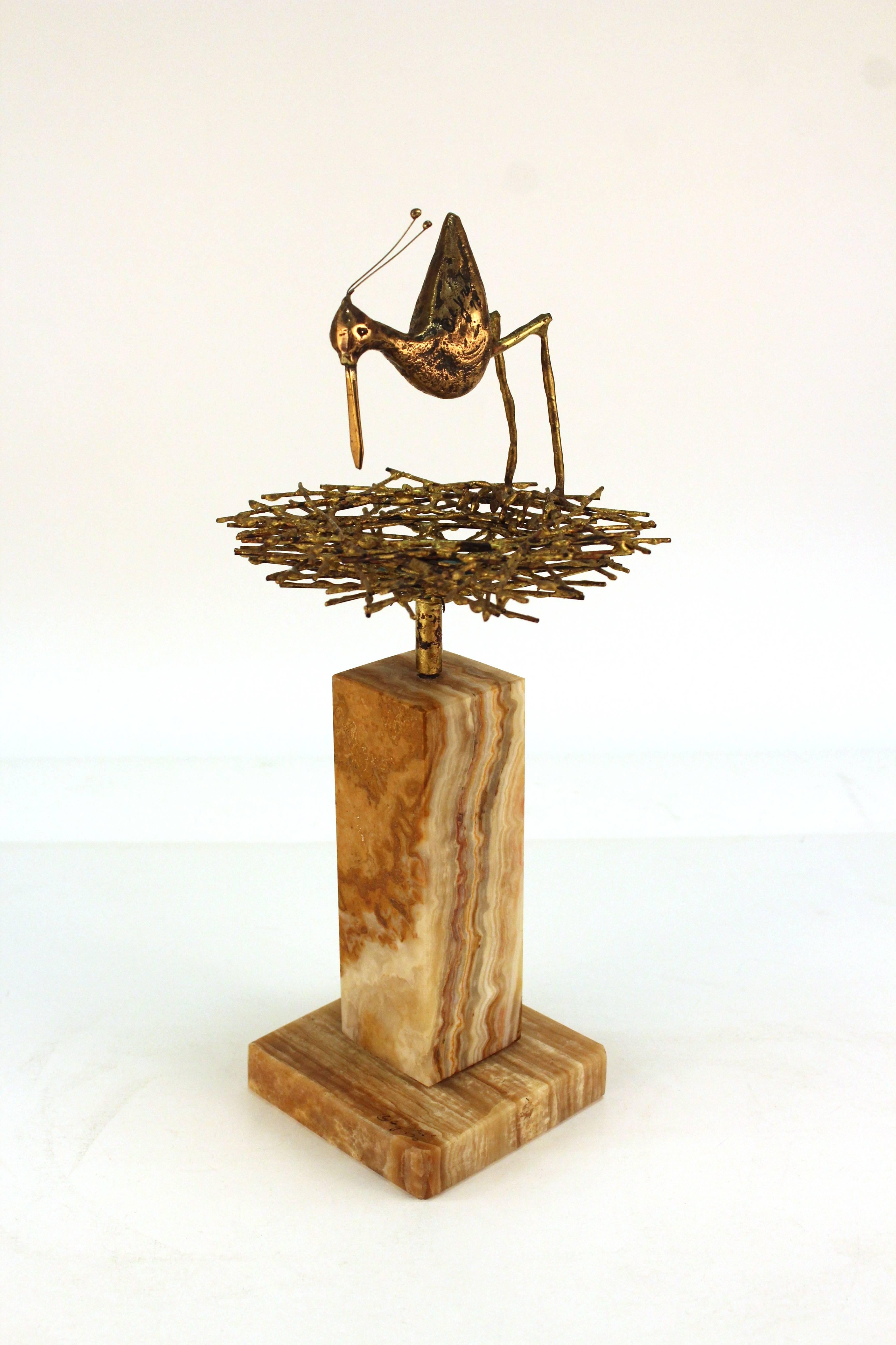 A Mid-Century Modern Curtis Jere sculpture of a sandpiper mother hovering over her nest with three blue eggs. Signed Curtis Jere on the marble base as well as on the body of the bird. In very good condition.