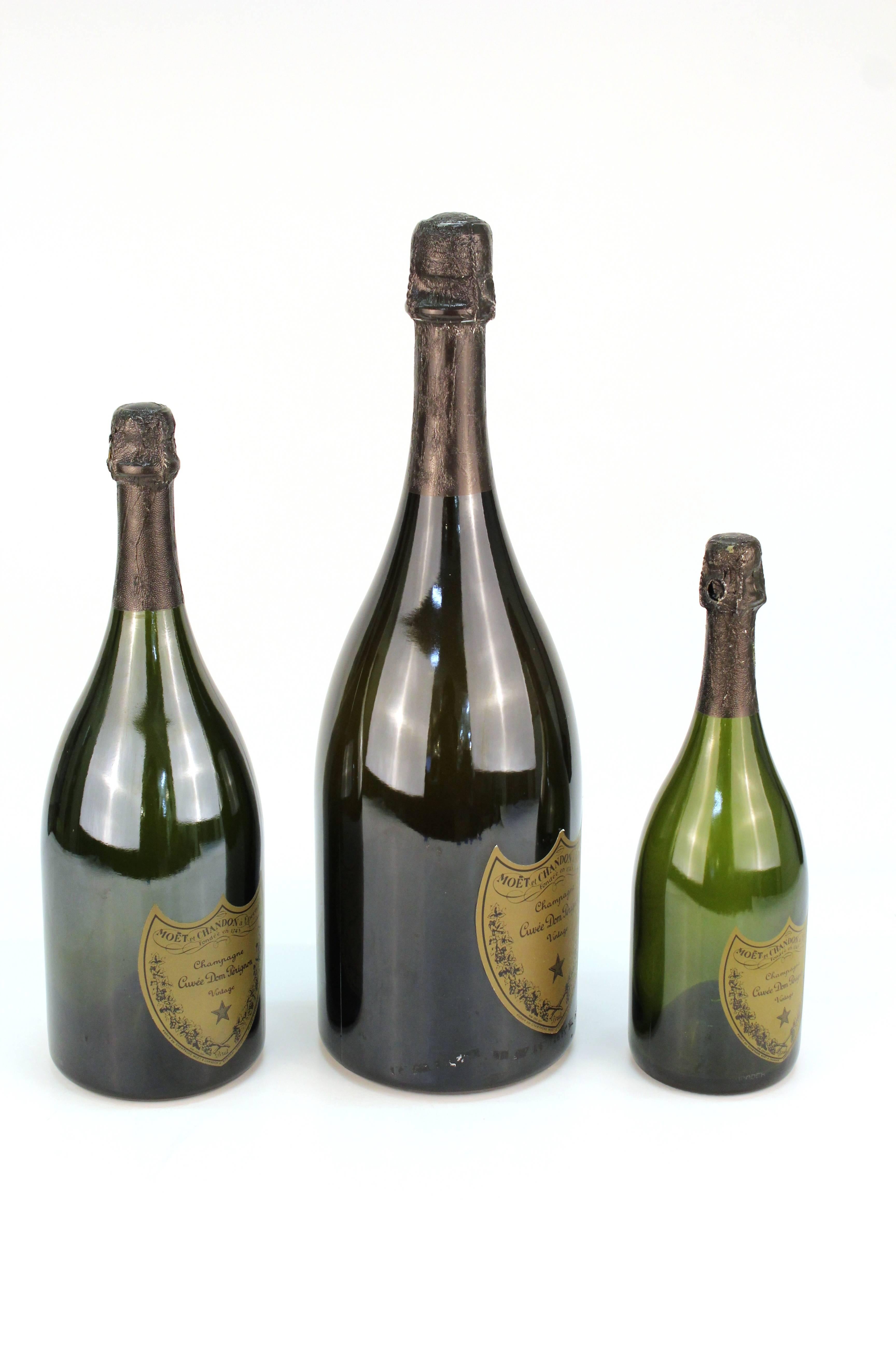 A set of three Dom Perignon champagne bottles from an advertising display. Three different sizes, each with labels and markings on bottom. Ideal for a decorative bar display.
Dimensions:
Small: 12