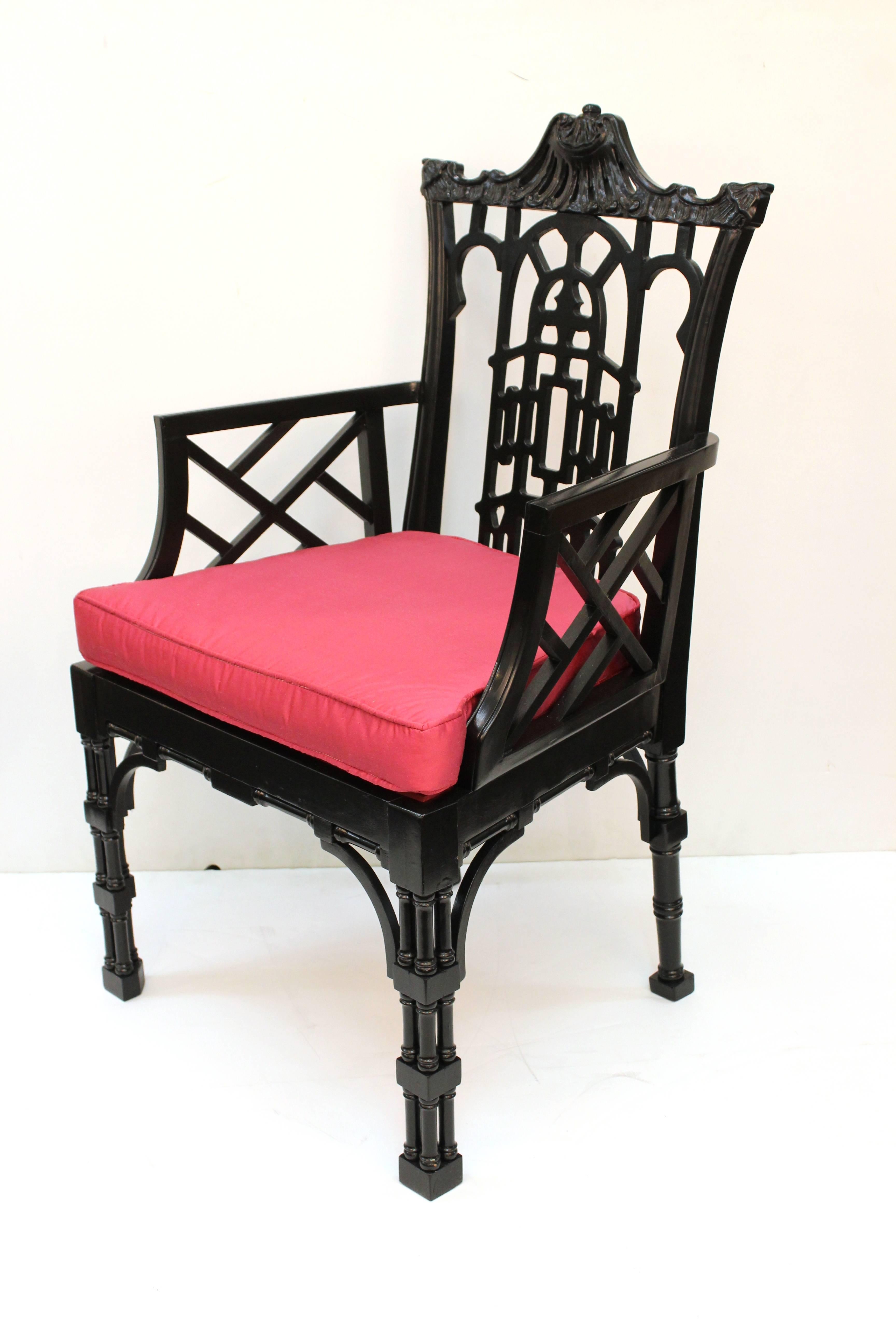 Pair of Hollywood Regency Chinese style Chippendale armchairs. Crafted in wood and finished with glossy black lacquer. Recently reupholstered in pink silk. In excellent condition.