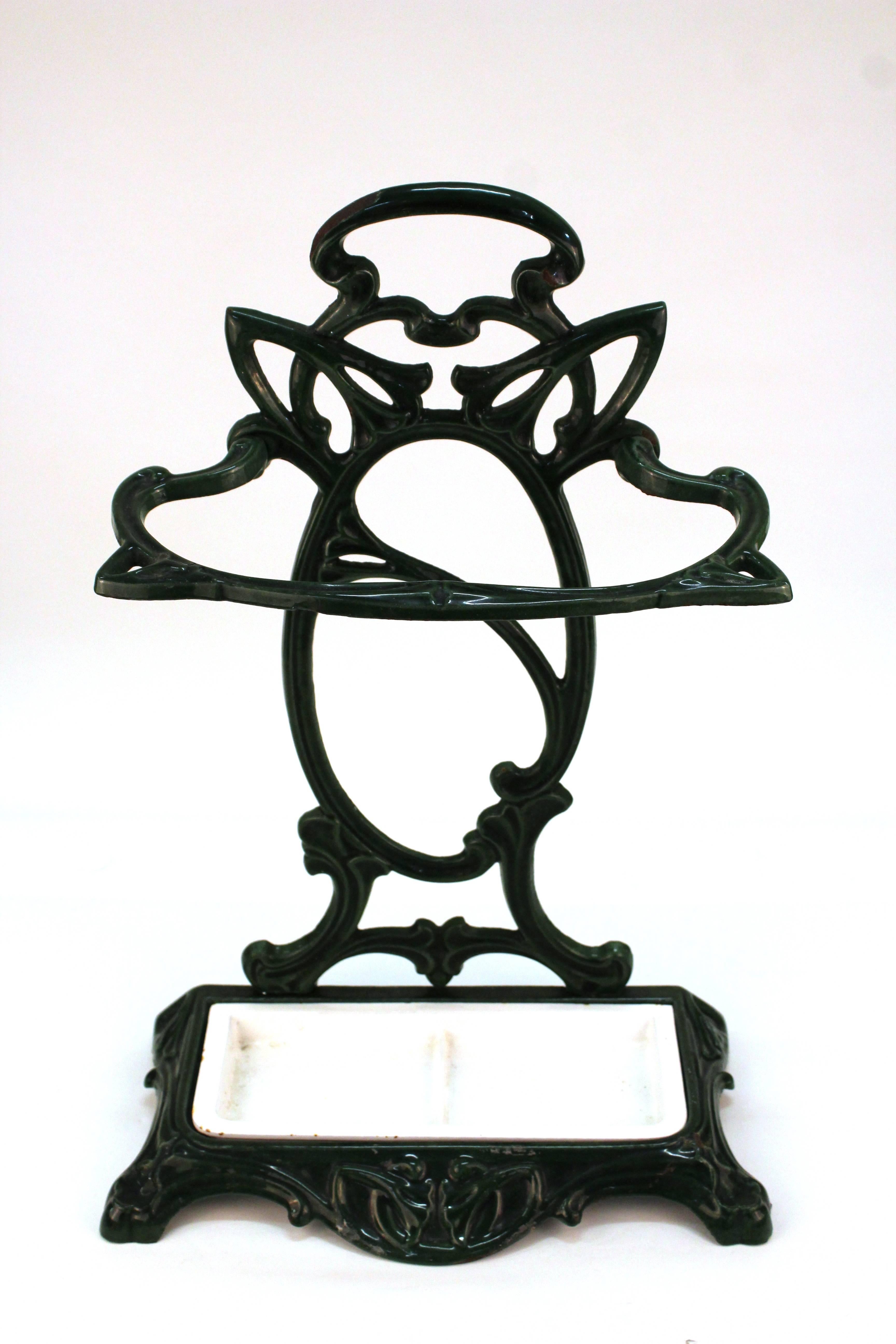 A French Art Nouveau umbrella stand in porcelain and cast iron, with original inserts, made in France by Castirone. Inserts crafted in white porcelain over cast iron. Great vintage condition.