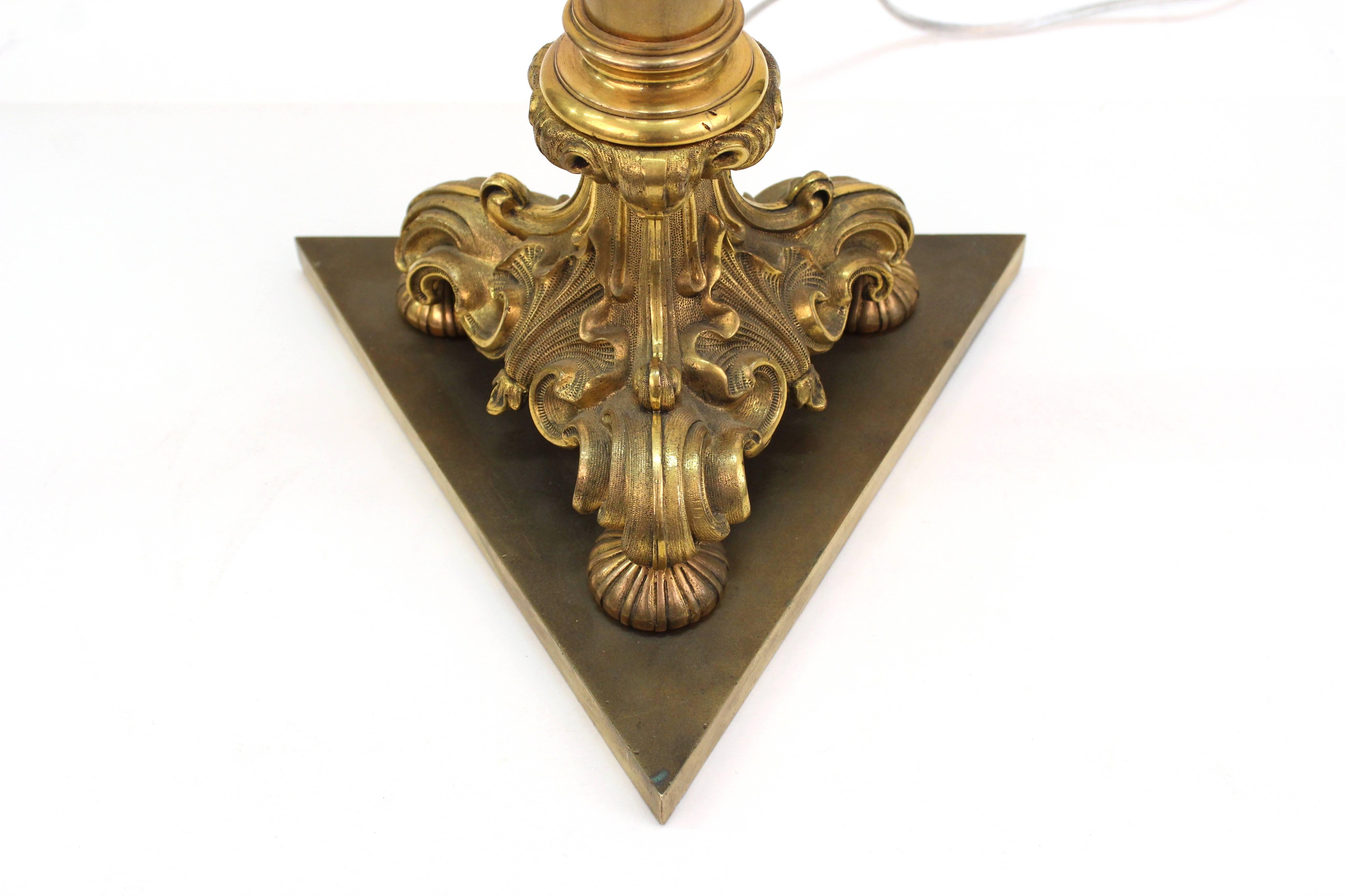 A pair of early 20th century neoclassical style bronze lamps with new mica shades. The lamps are newly rewired and in excellent condition. Maximum height to finial is 38 inches.
