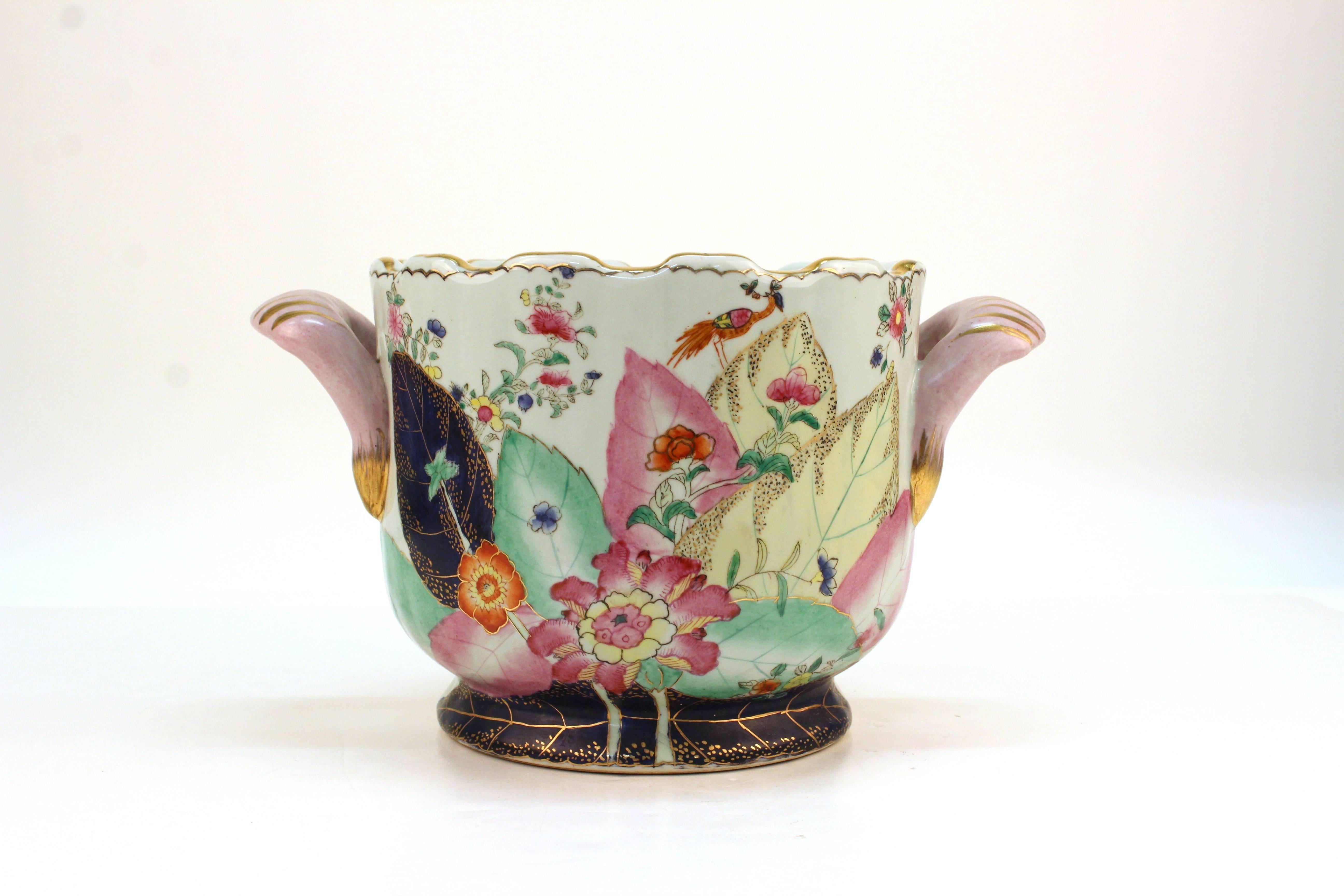 Chinoiserie style porcelain pot with colorful tobacco leaf pattern. Styled with scalloped edges and two handles. Stamped at the bottom with a maker's mark and [porcelain]. Wear appropriate to use. In good condition.