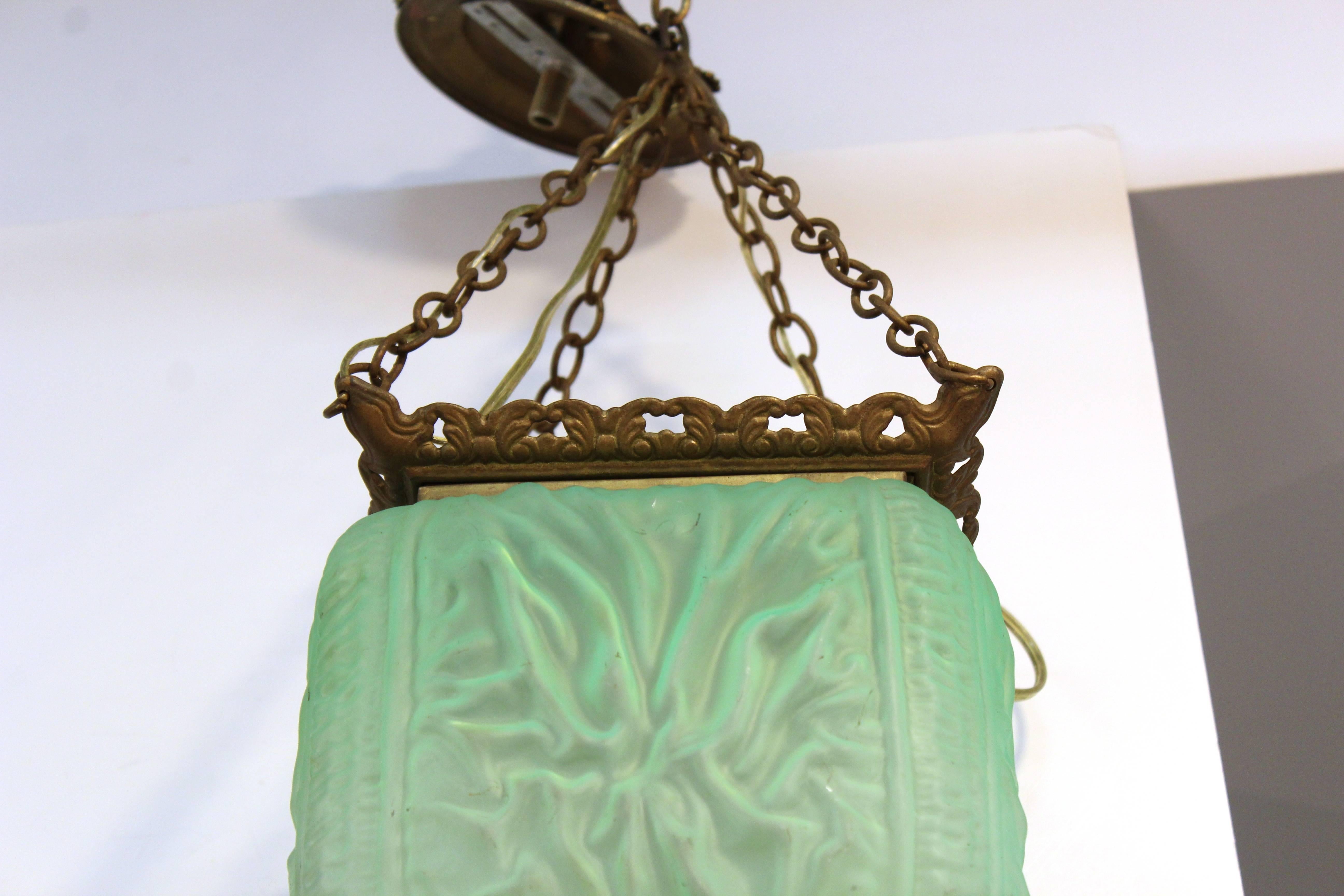 Antique chandelier with quilted satin glass dating from the 1870s. The green glass is a unique and rare color. Includes the original brass canopy and fittings. Newly re-wired. Takes Edison base bulbs. The pendant is in excellent condition.