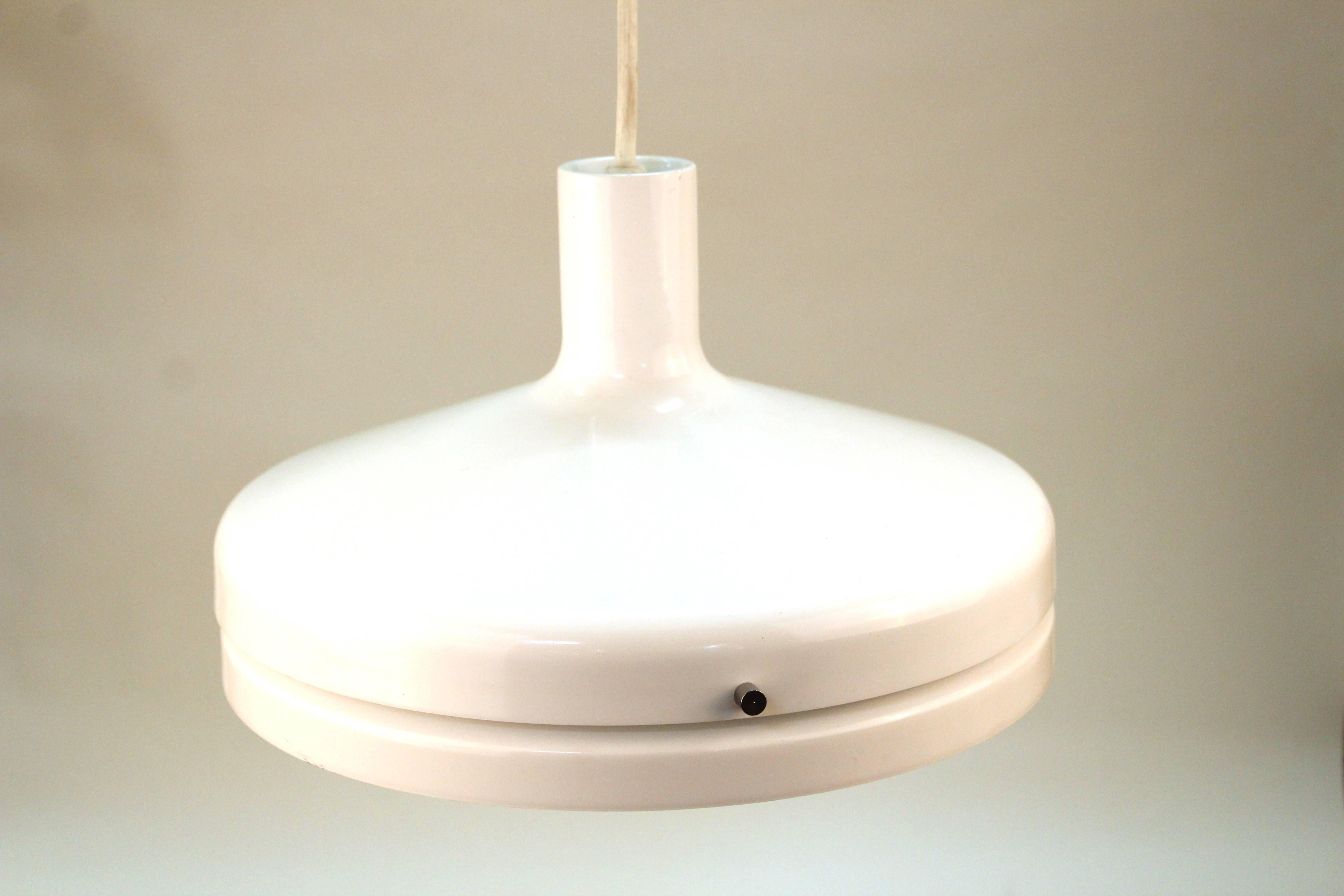 A white pendant light fixture by Lightolier. Manufactured in a saucer shape. The fixture includes the original label. Wear consistent with use. The pendant is in good condition.