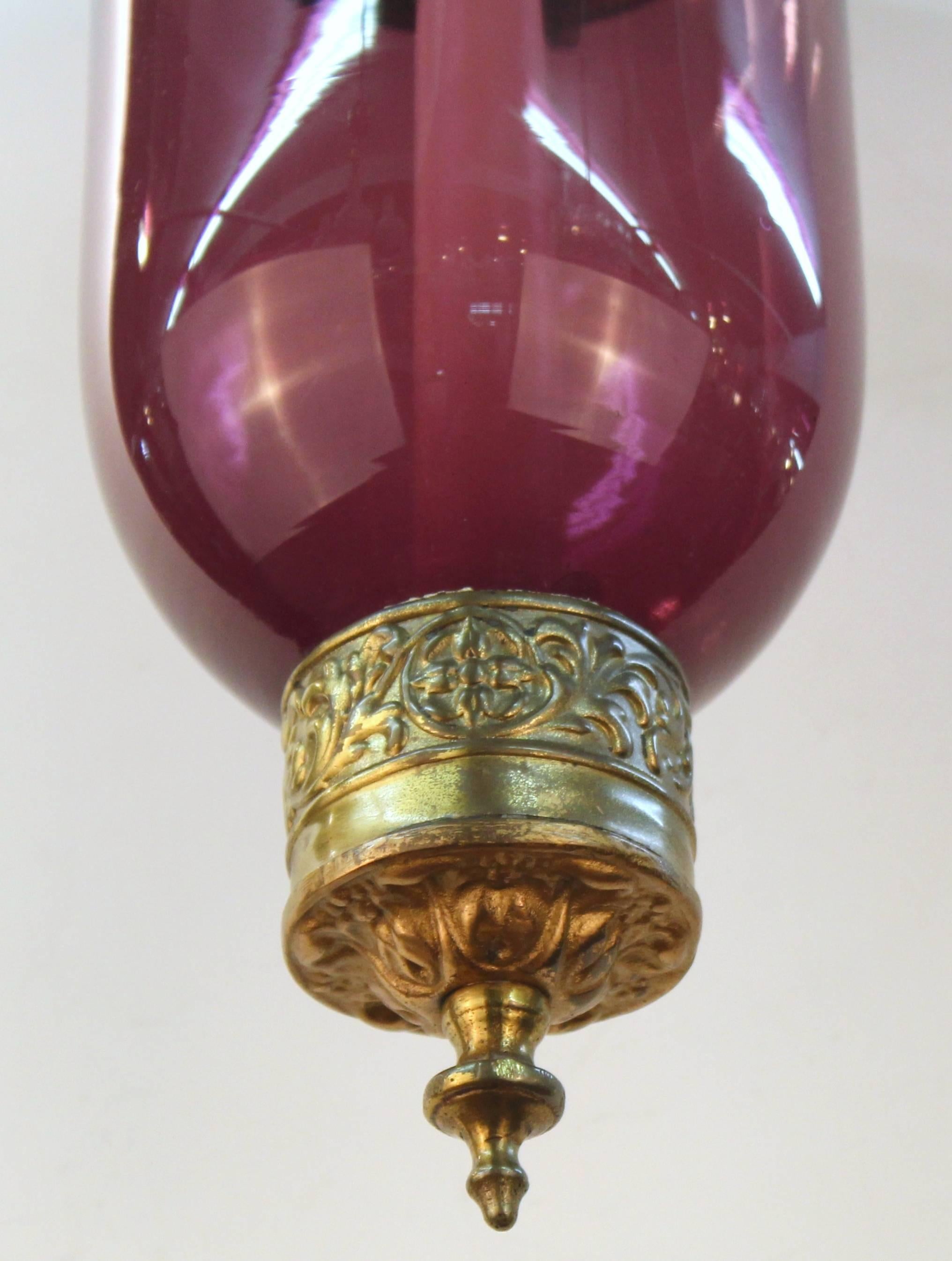 English Regency bell jar lanterns in amethyst colored glass with brass accents featuring a swan motif. Each of these lanterns has not been electrified and features a blown glass ceiling cap. These lanterns are in excellent vintage condition and have