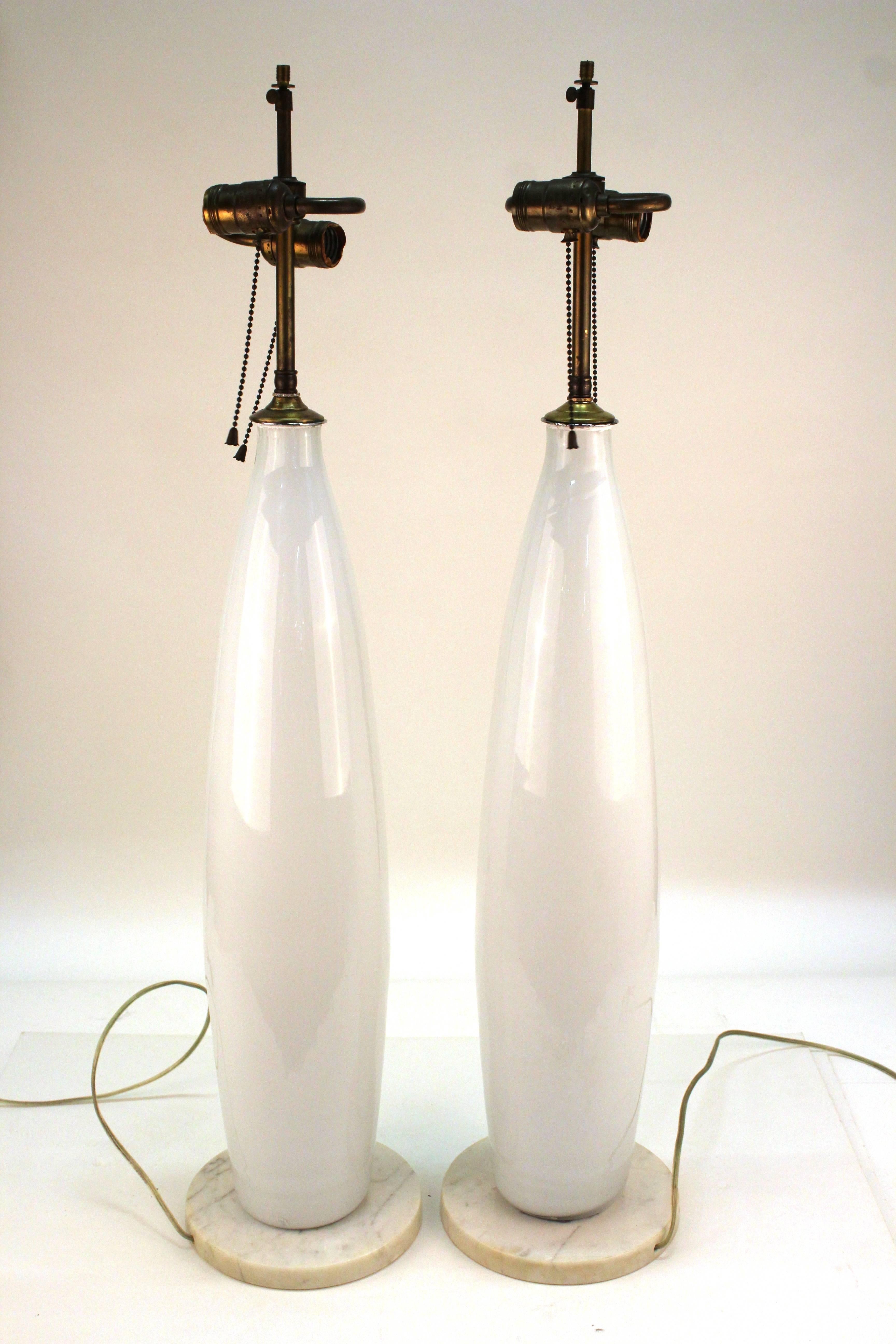 Venetian Balboa glass pair of tall table lamps in white glass atop a circular white Italian marble base. The lamps are rewired and in great vintage condition. Label on glass reads 