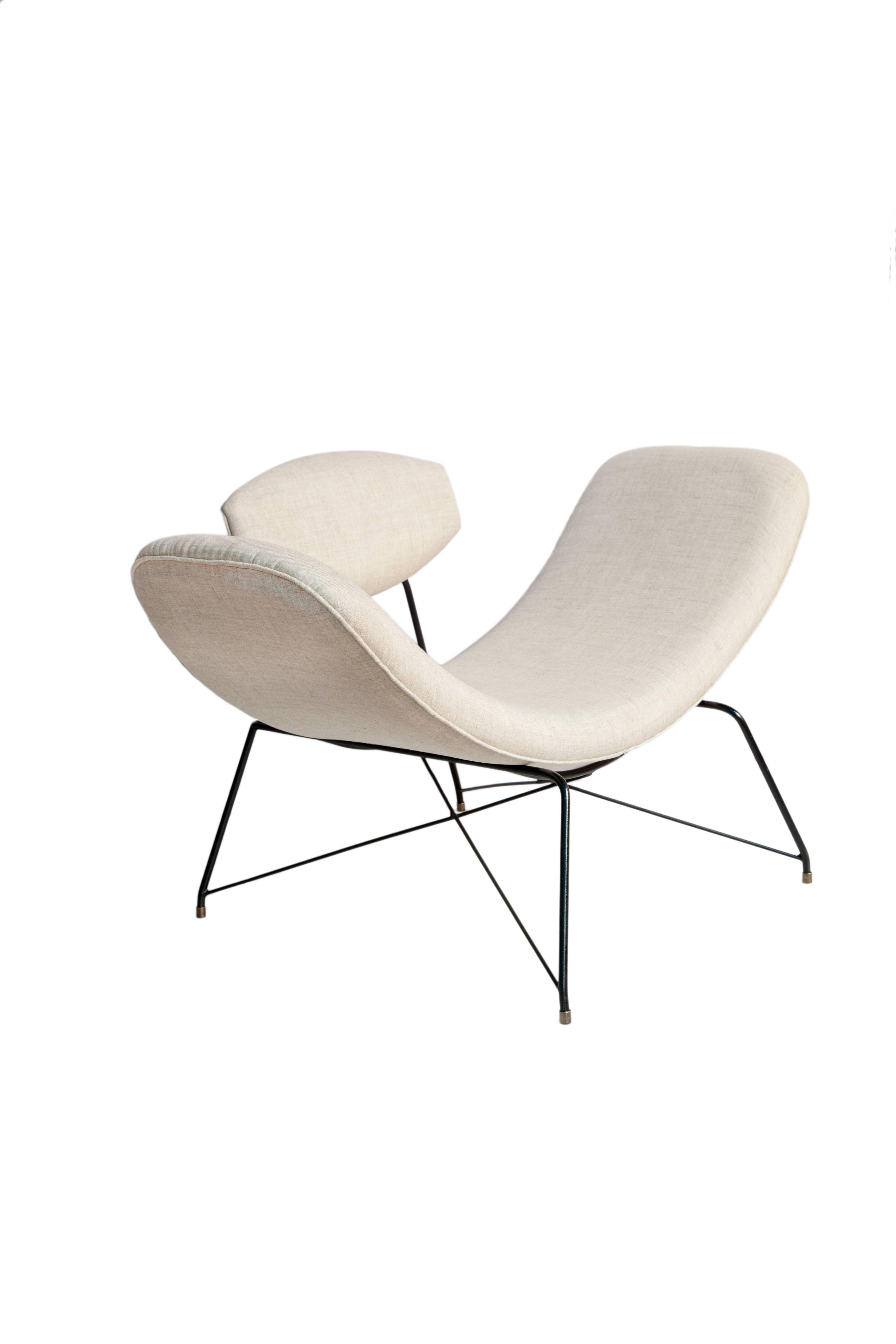 Reversible Brazilian Mid-Century Modern armchair designed by Martin Eisler & Carlo Hauner from the 1950s. This piece has iron frame and recently reupholstered white linen seat and back. The seat slides horizontally to become similar to a chaise