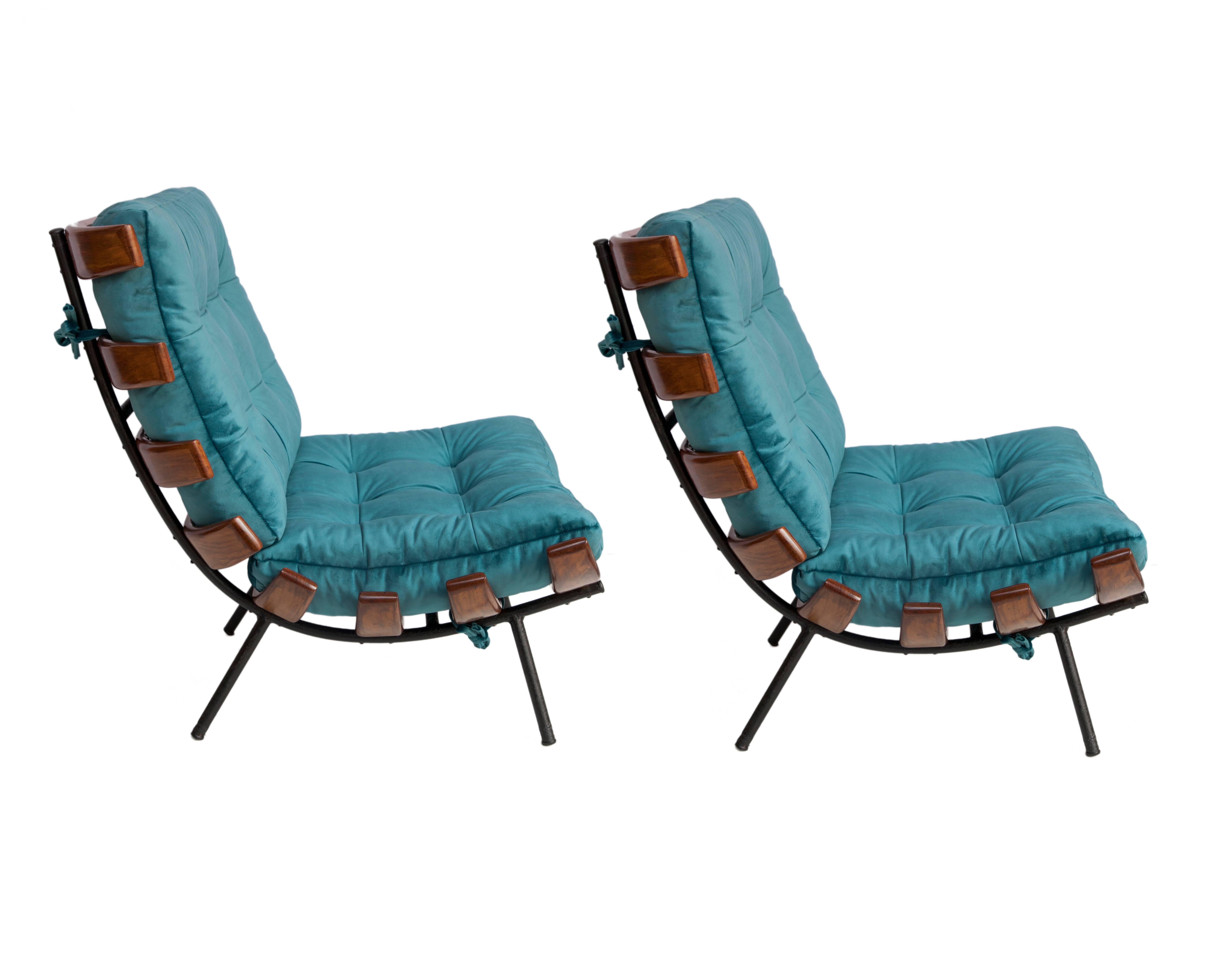 Rib chairs (also called Costela chairs) designed by Martin Eisler and Carlo Hauner in Brazilian caviuna wood and metal. These chairs are iconic Brazilian Mid-Century Modern pieces and date from circa 1950. Each chair has been recently reupholstered