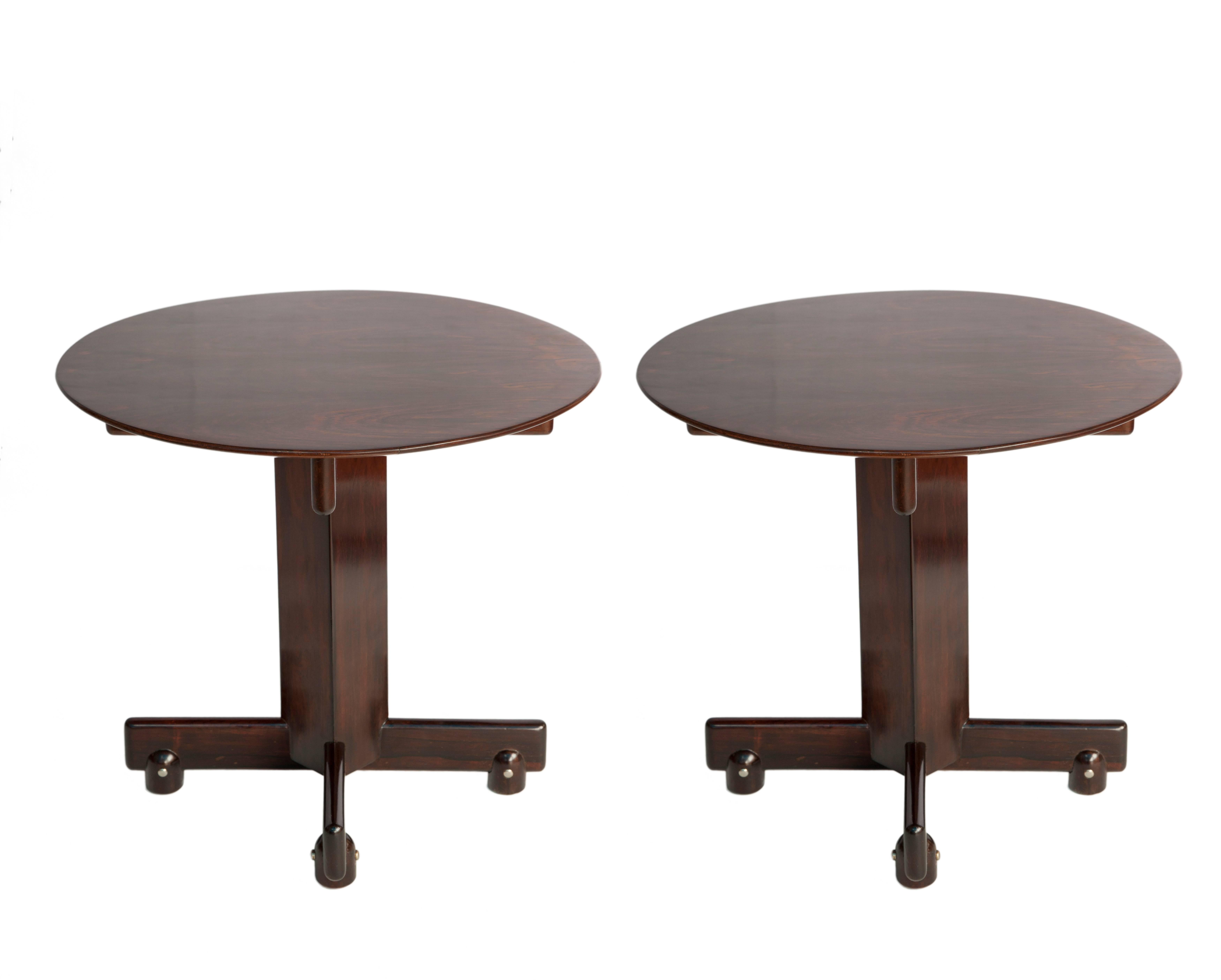 Mid-Century Modern Brazilian Alex side tables by Sergio Rodrigues. Dating from 1960s Brazil. Completely crafted in Jacaranda wood with circular tops. The pair stand on square pillar bases and four legs. The tables are in good vintage condition with