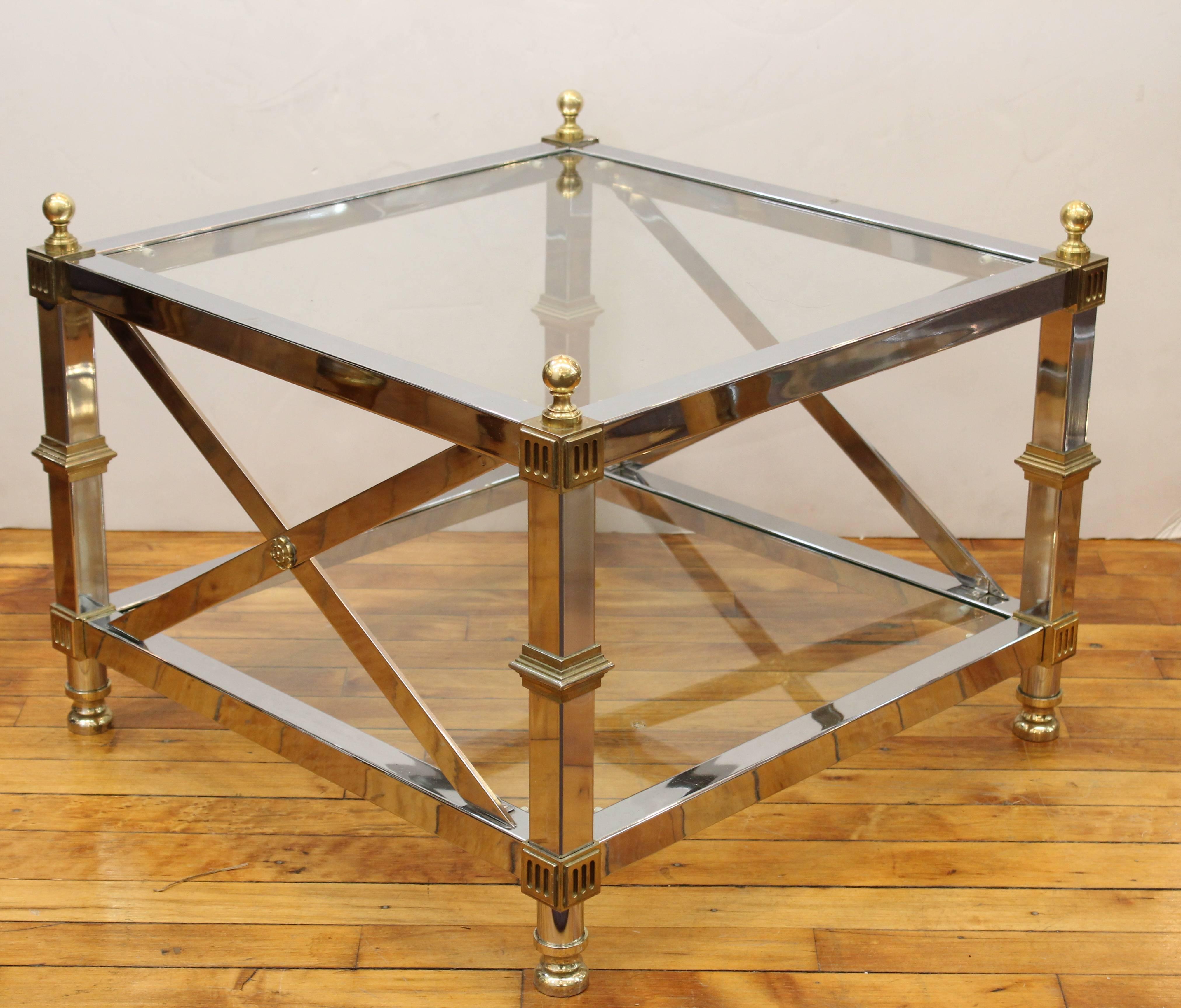 A pair of Maison Jansen chrome, glass and brass coffee tables, in the French Directoire style with decorative rosettes, made in the 1950s in France. In very good condition.