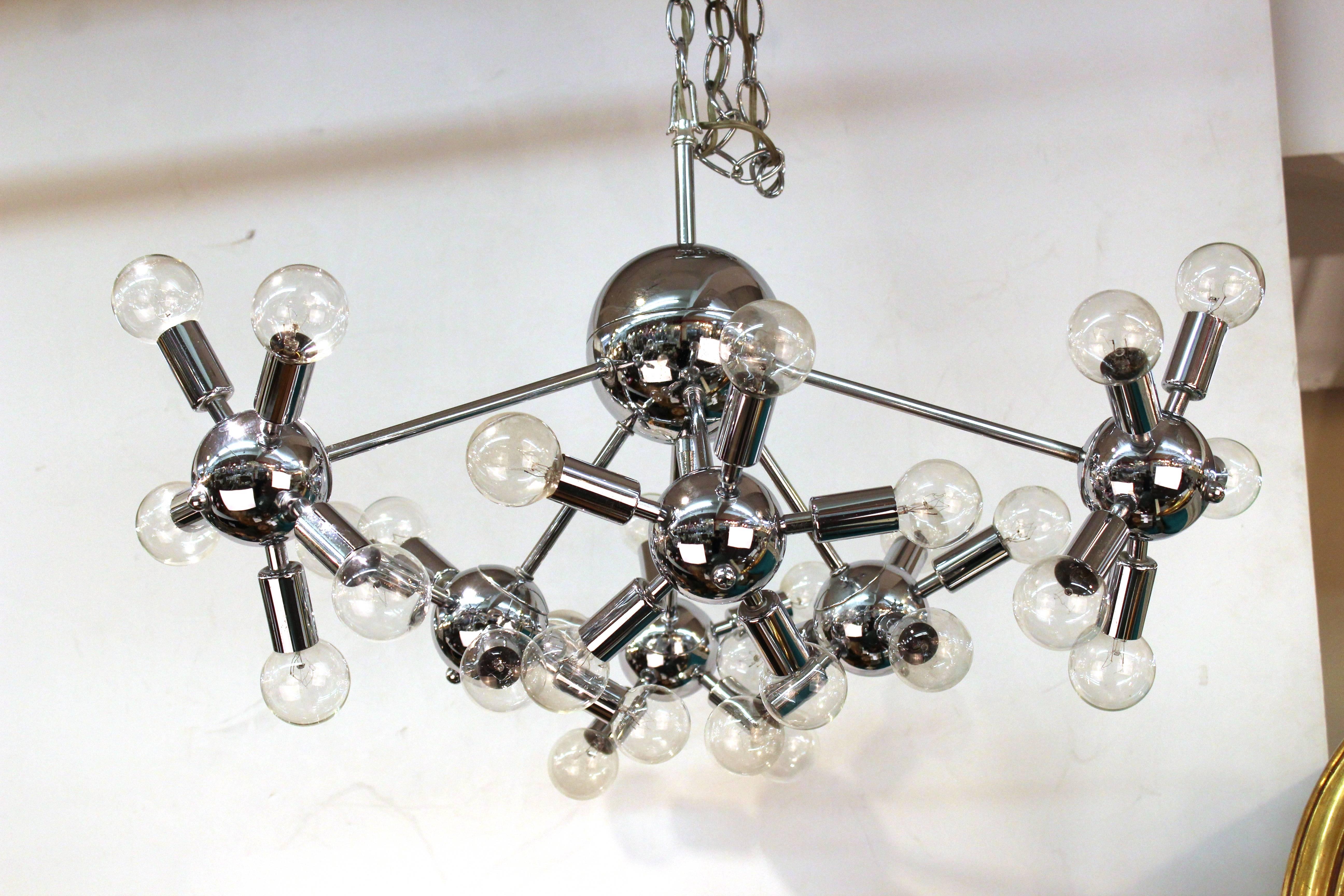 Large Mid-Century Modern chrome Sputnik chandelier, made in Italy during the 1970s. The chandelier has a total of 24 lights and has recently been rewired to fit US standards. In very good vintage condition.