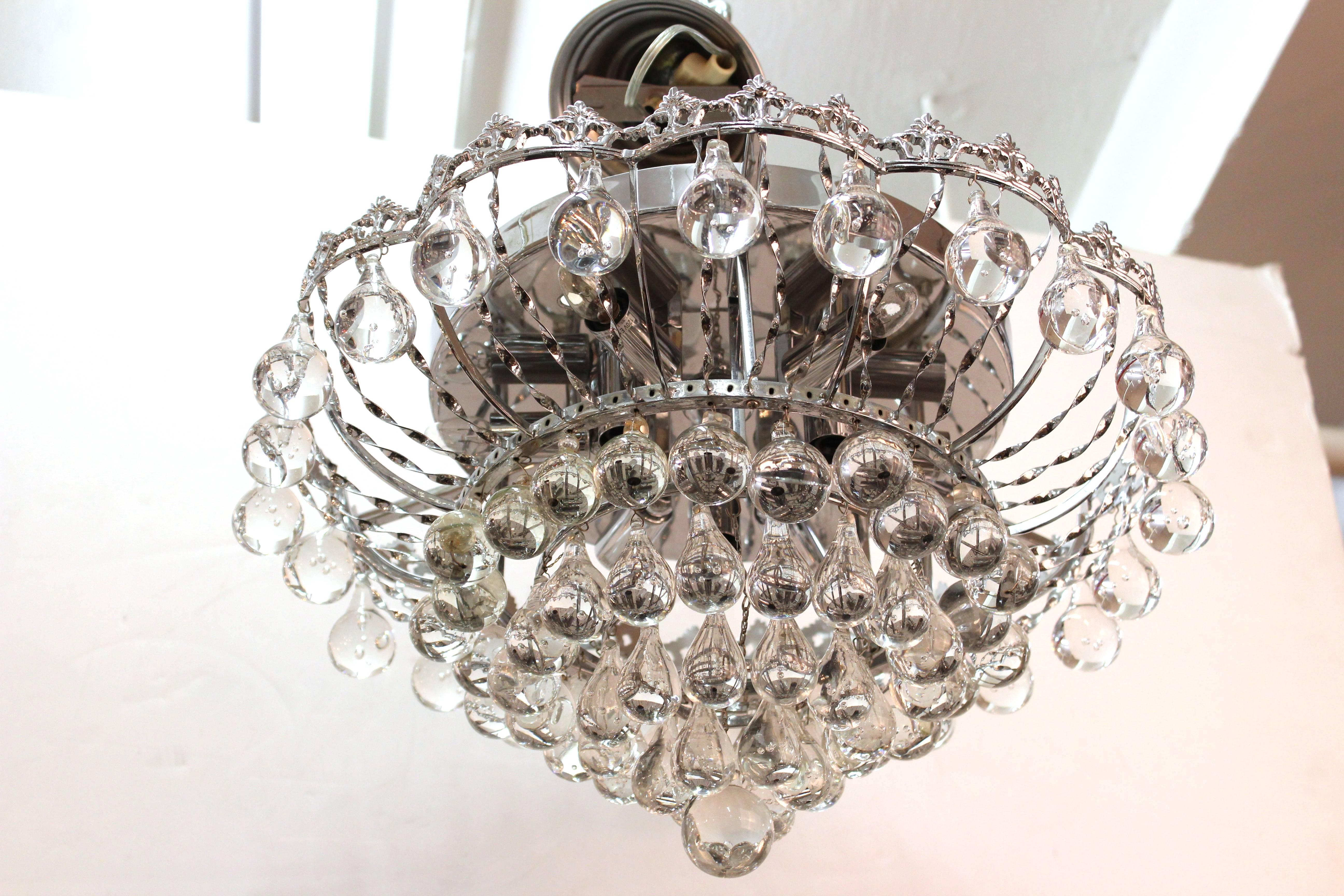 A Mid-Century Modern chrome chandelier with dropped crystal balls throughout each level. This chandelier was made in Italy in the 1950s and has recently been re-wired to conform with US standards. In excellent vintage condition.