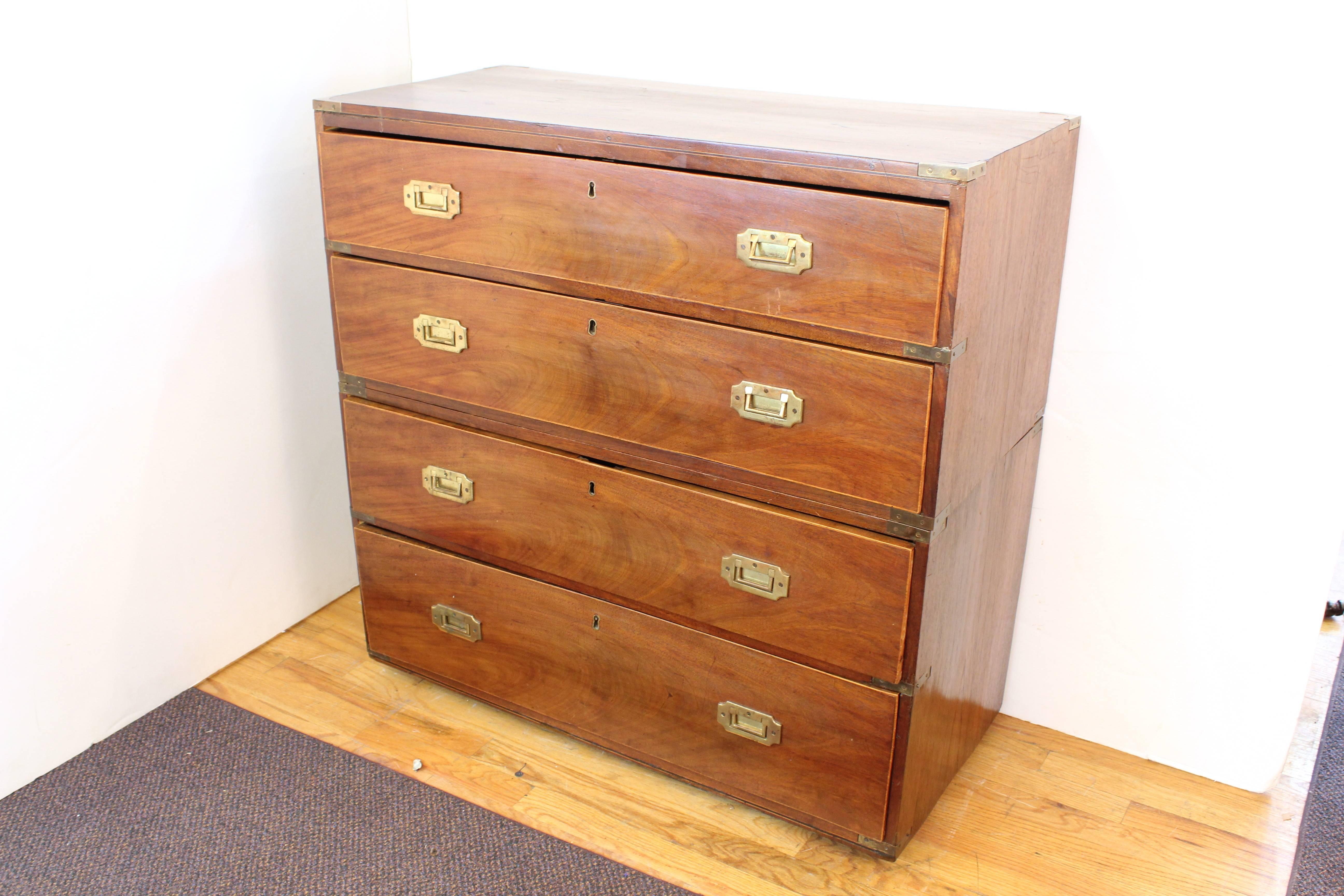 A mahogany wood campaign chest in two segments, made in the 1860s, of the Victorian era. Flush-mounted hardware and recessed handles in brass. Four full-length drawers, two on each segment. In overall good vintage condition with age appropriate wear