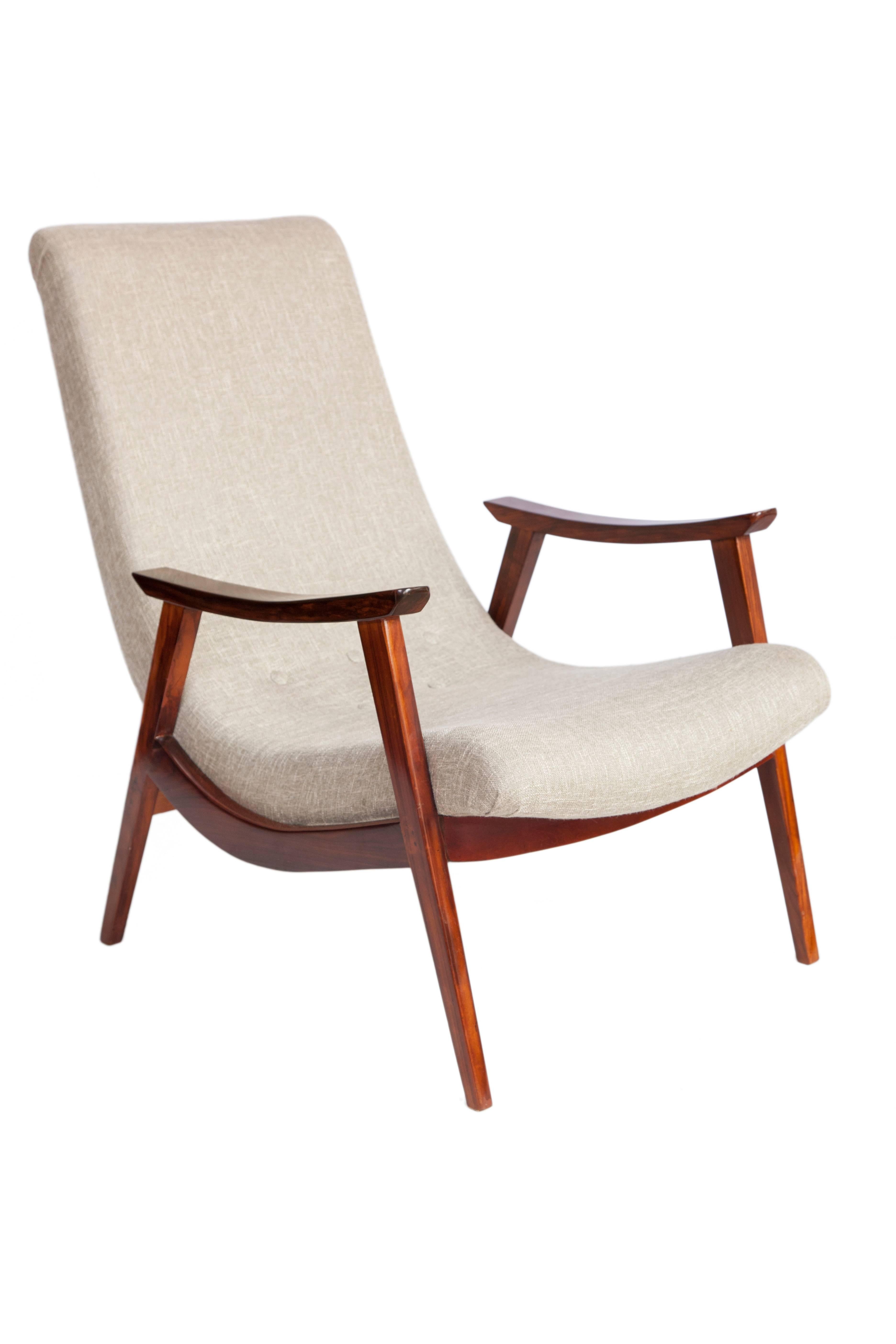 Brazilian modern armchair designed by Gelli, circa 1950. Produced in Jacaranda wood with recently re-upholstered seat in beige linen. Features gently curved front legs and carved armrests. The chair remains in good vintage condition.