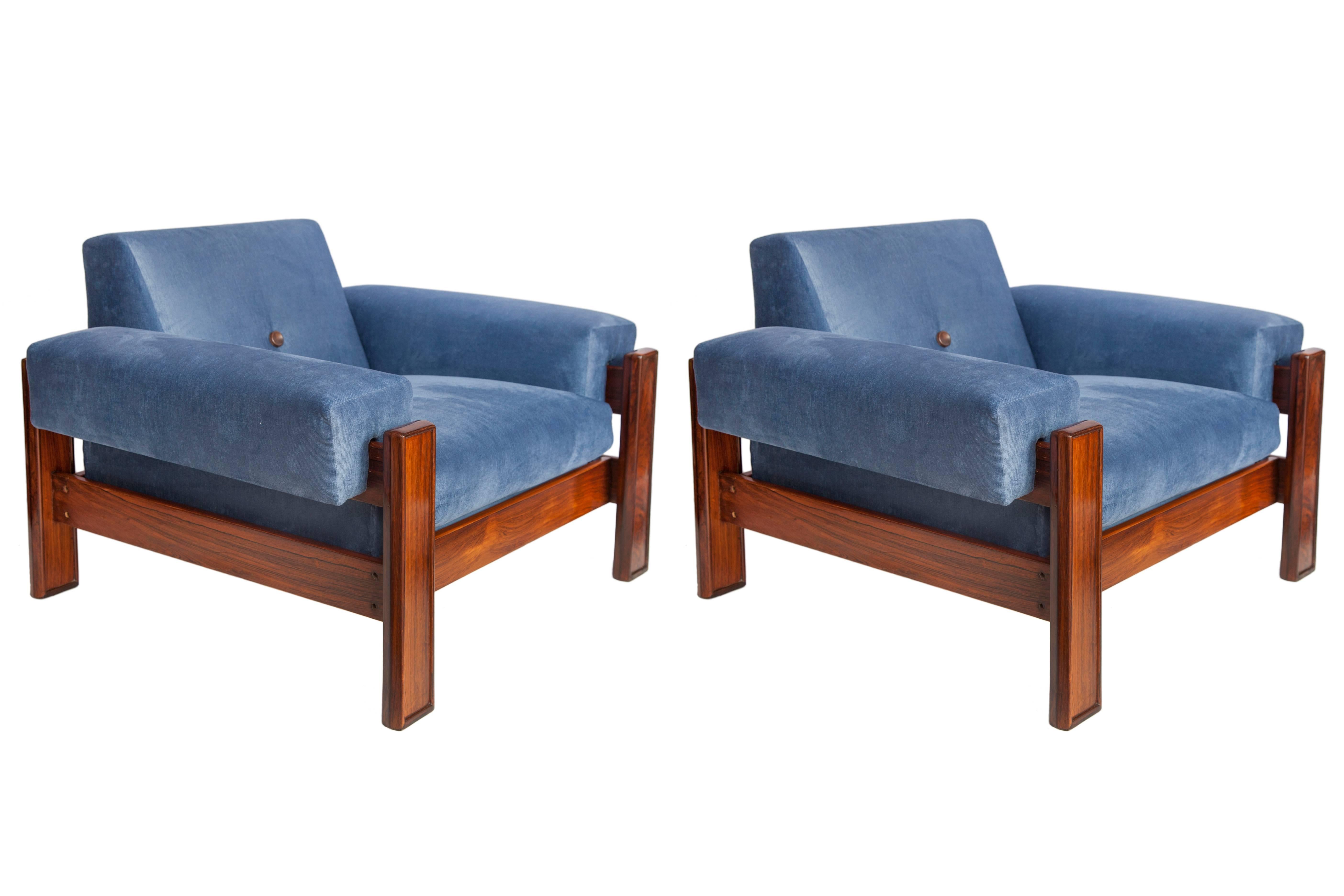 Mid-Century Modern armchairs in Brazilian jacaranda and blue upholstery from circa 1960. These chairs have been recently reupholstered in mixed polyester and viscose velvet. Each is in good vintage condition and has wear consistent with age and use.
