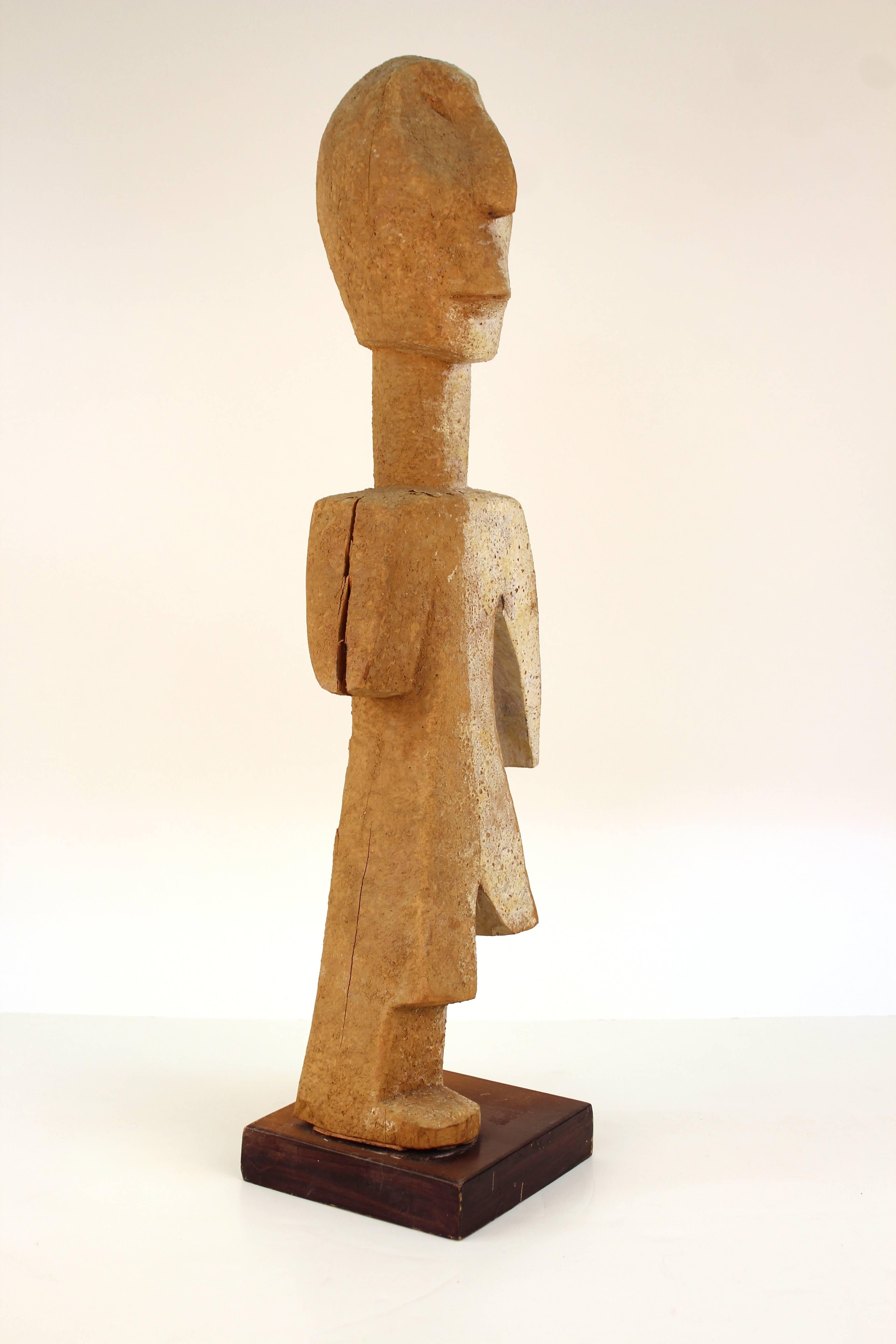 Figural sculpture on a dark wooden stand. Depicts a person in abstract organic forms. One side without an arm and the other without a leg. wear appropriate to age and use the piece is in good condition. 