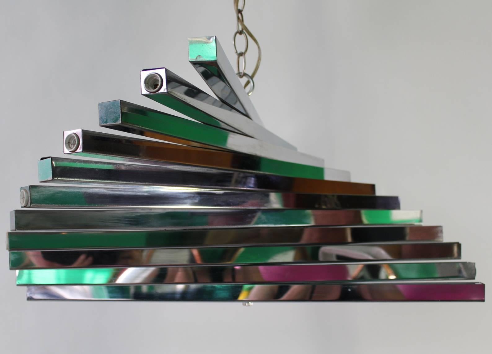 Mid-Century Modern spiral chandelier by Italian designer Gaetano Sciolari in chrome. This chandelier features 11 chrome bars and has five lights on each end. Includes 8 foot chain and canopy. If desired, the chain can be shortened. In good vintage