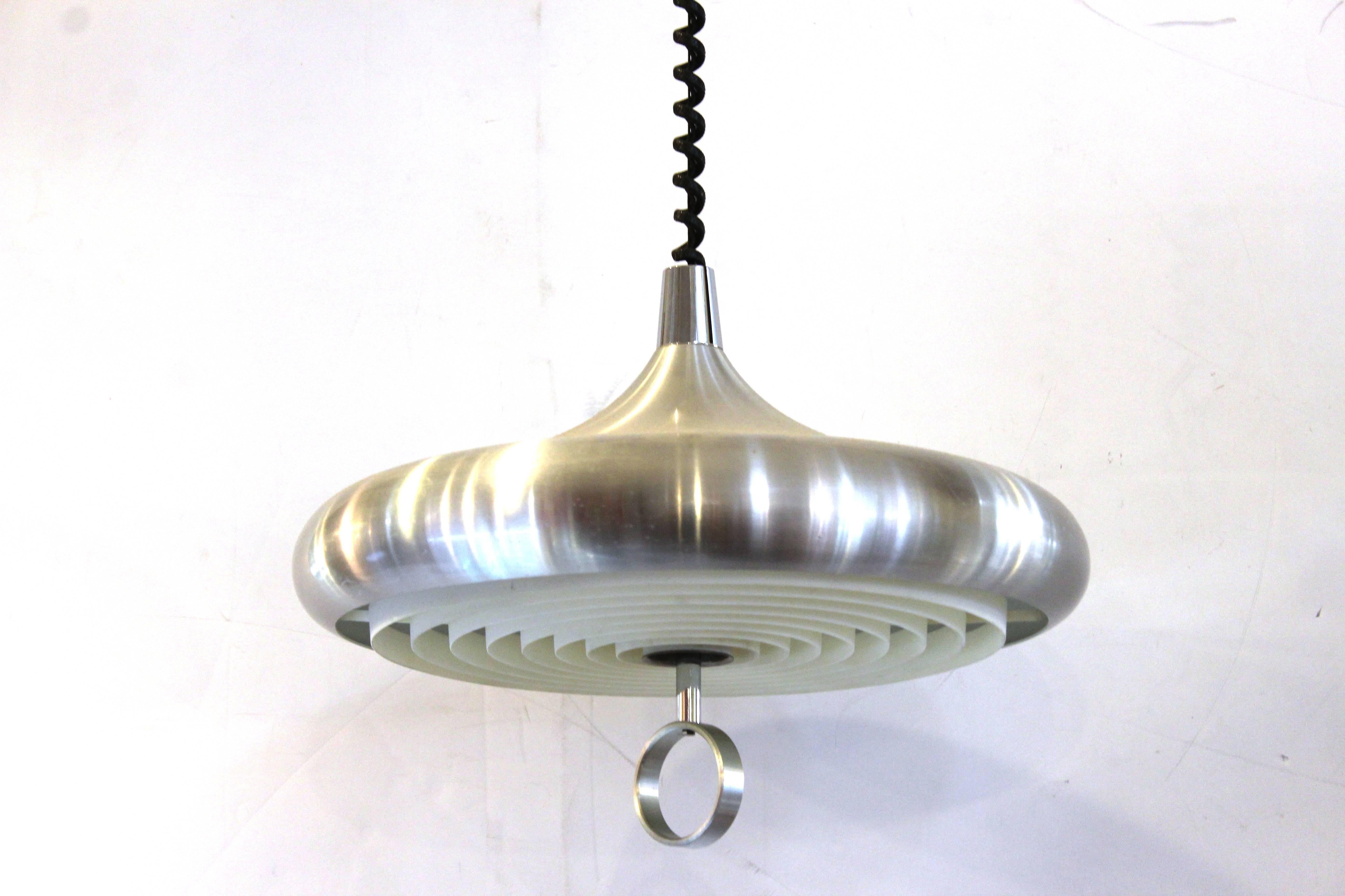 Op-art pendant light in aluminium and chrome. Saucer shaped with plastic diffusers and 'O' shaped finial. The height is adjustable. Wear appropriate to age and use. The fixture is in good condition.