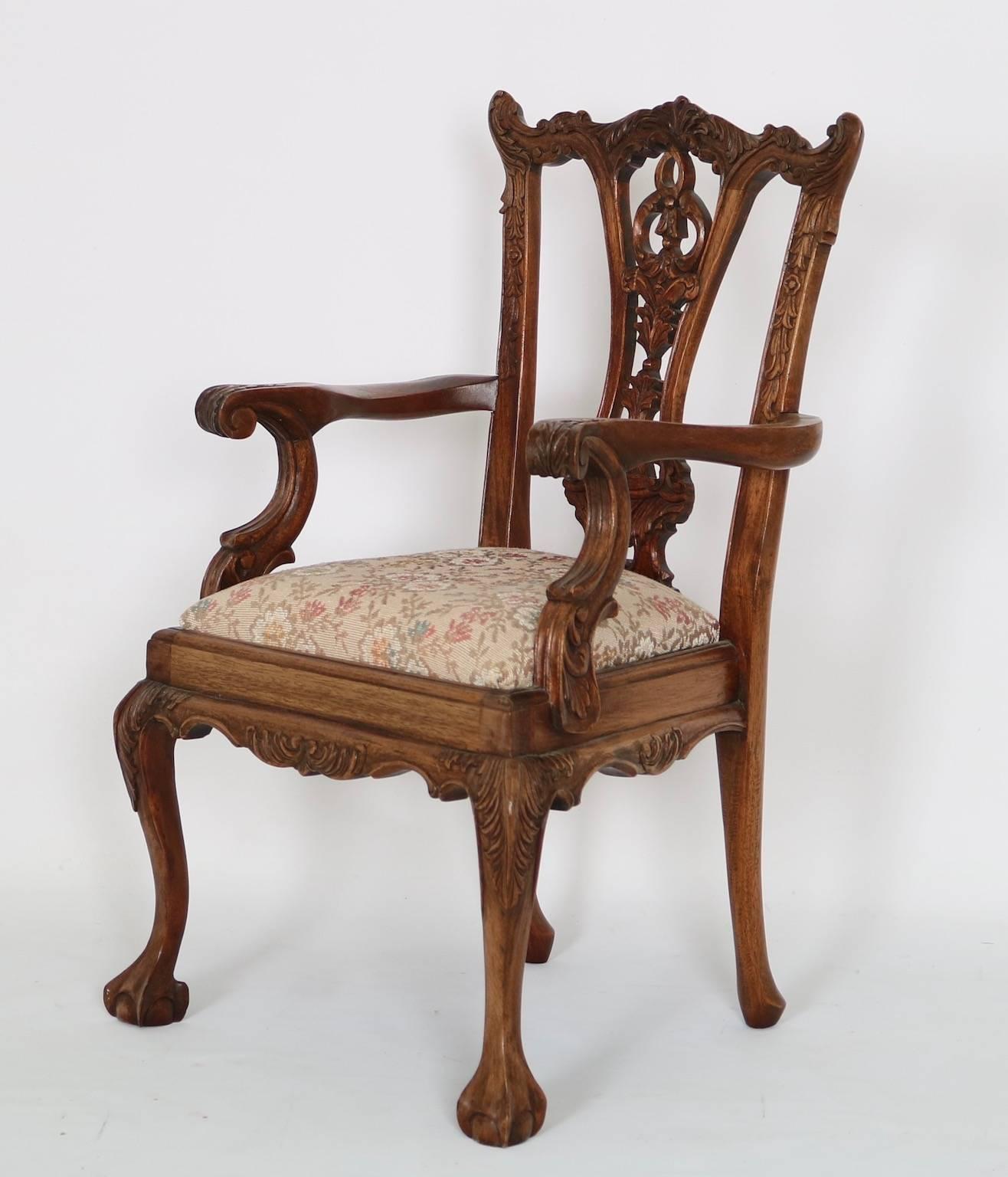 Chippendale style doll's chair dating from the 1940s with ornate foliate wood carving and cream-color upholstered seat. This piece is in very good condition and has wear consistent with age and use.
