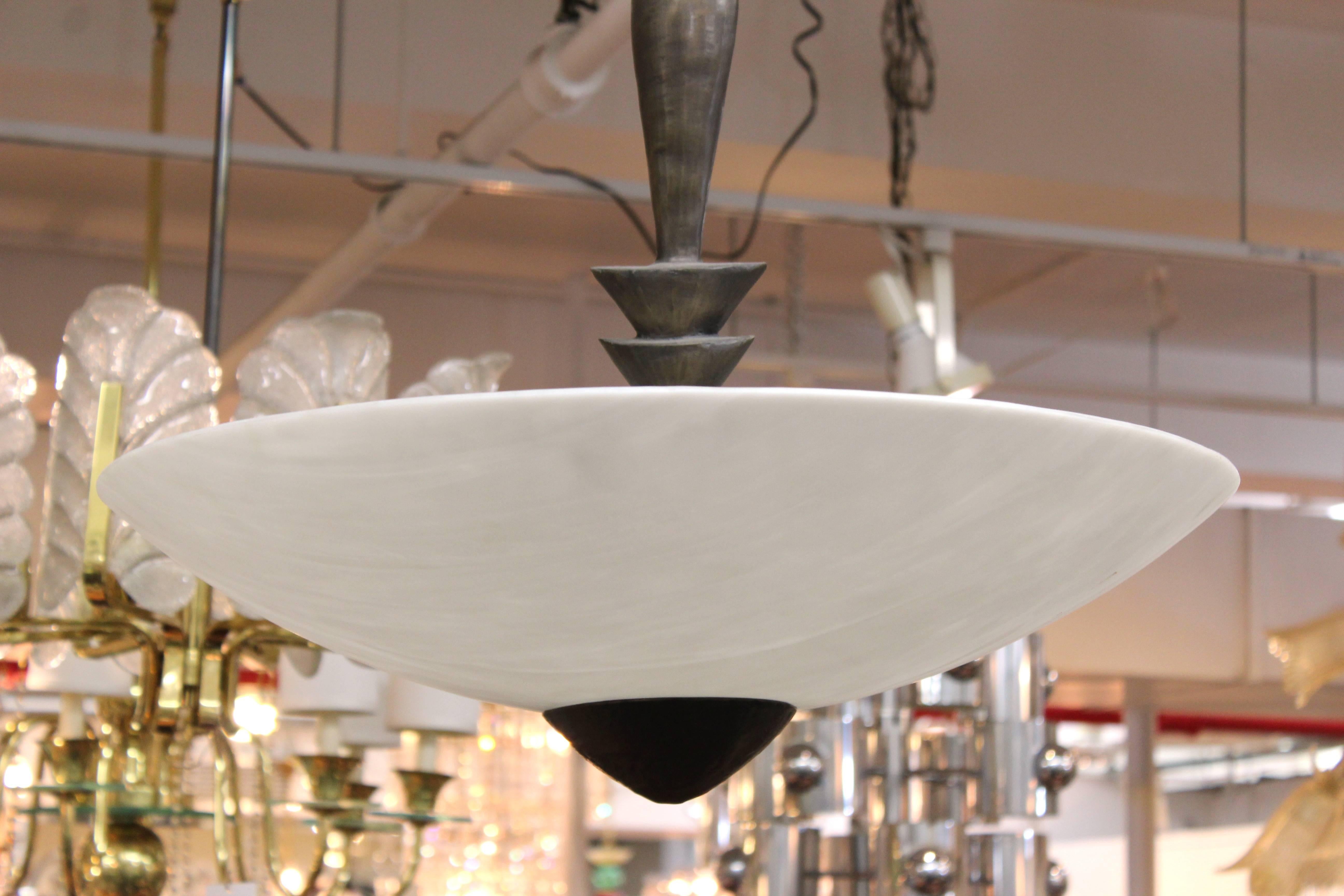 Chandelier in the style of Alberto Giacometti with a large white dome or bowl shade. The lamp comes with an equally substantial matching canopy and has three bulb sockets. This fixture is in good vintage condition and has wear consistent with age