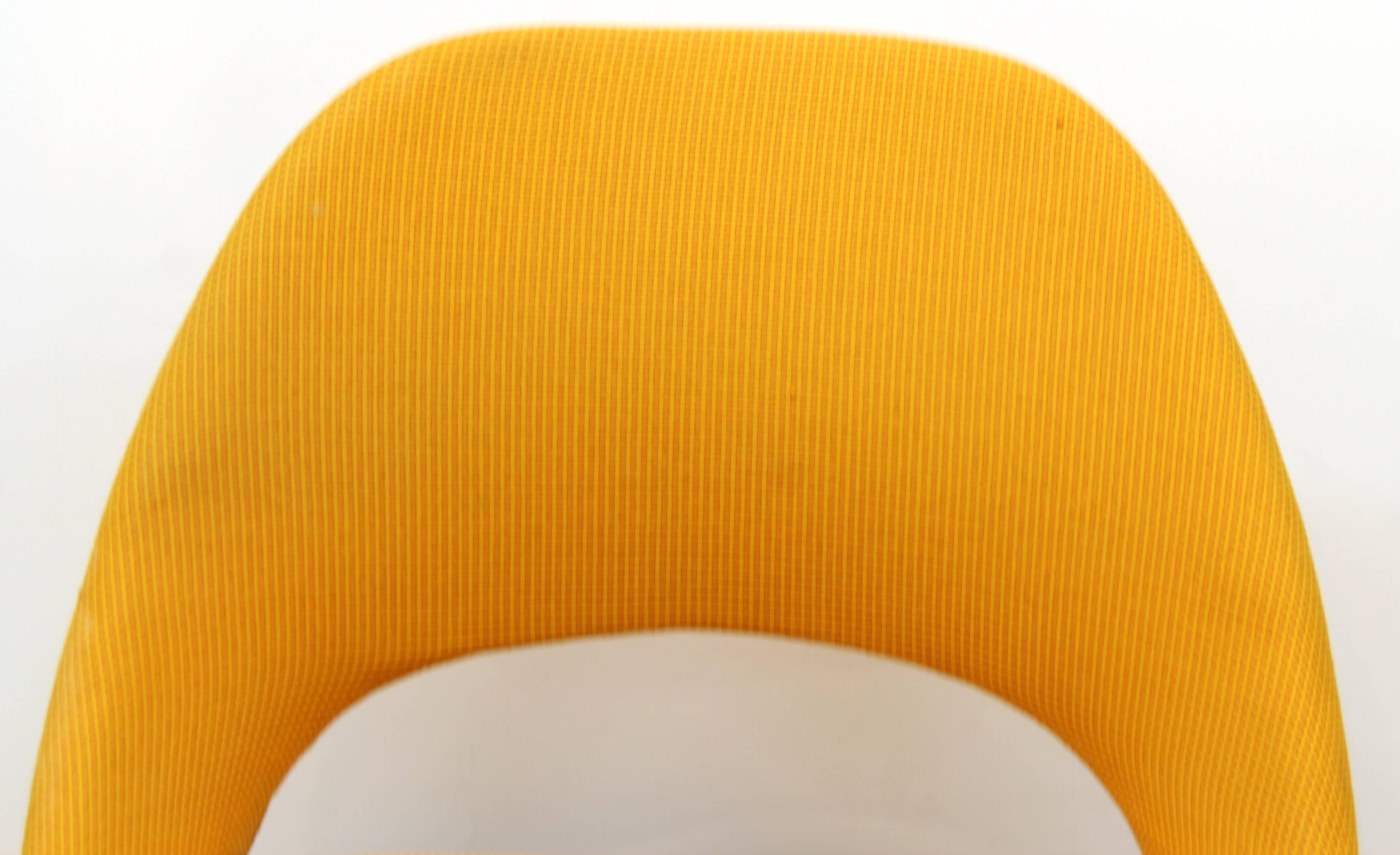 Swivel chairs designed by Eero Saarinen for Knoll international in chrome with a golden yellow upholstery and propeller base. Each chair has the original labels. This pair is in good vintage condition and has wear consistent with age and use.