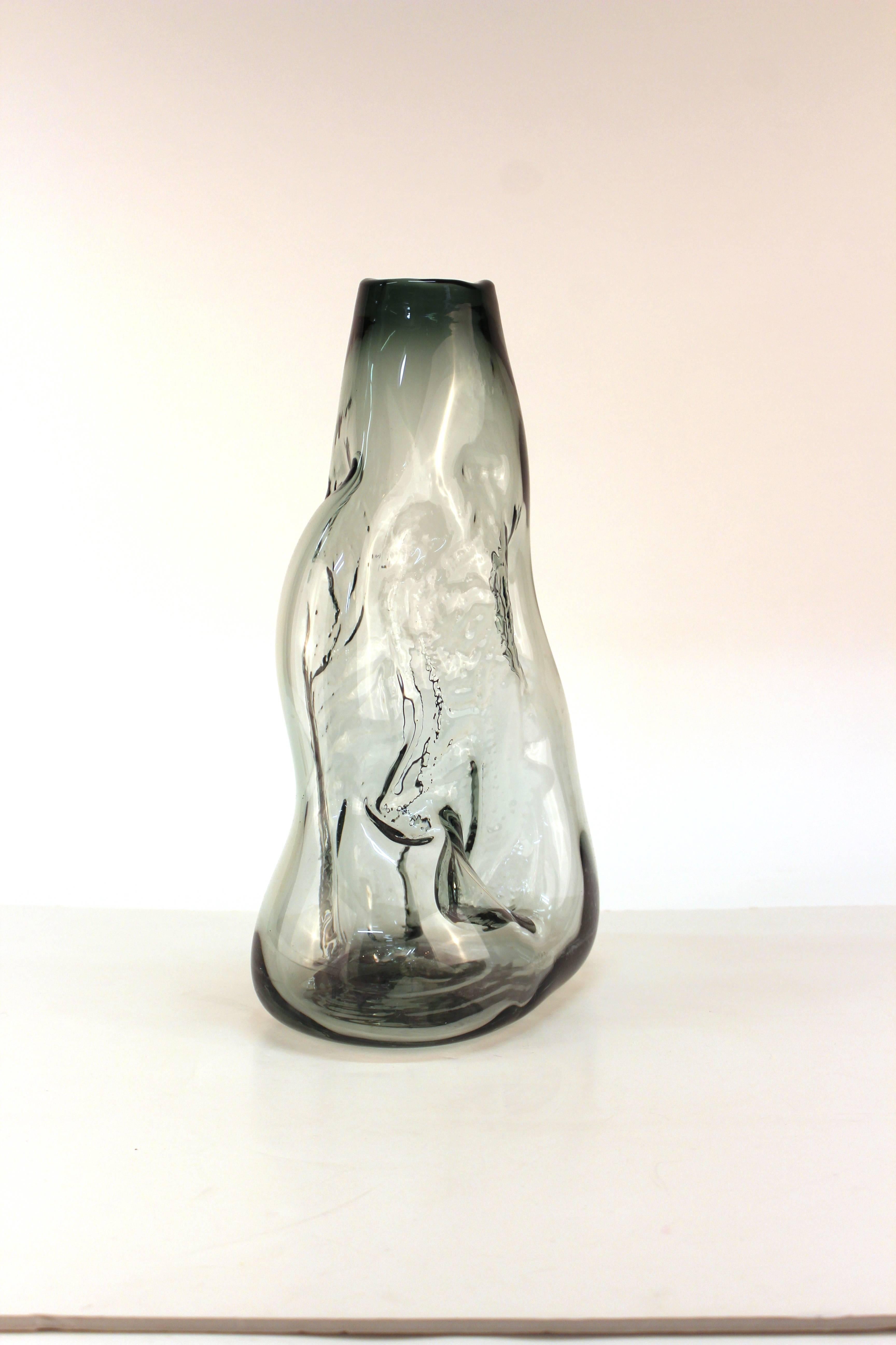 Don Shepherd for Jonynas and Shepherd Studio, glass vase blown into organic shape. The vase is in a pale smokey gray and features impressed designs. Includes raised pontil on the bottom from the crafting process. Crafted during the 1970s the piece