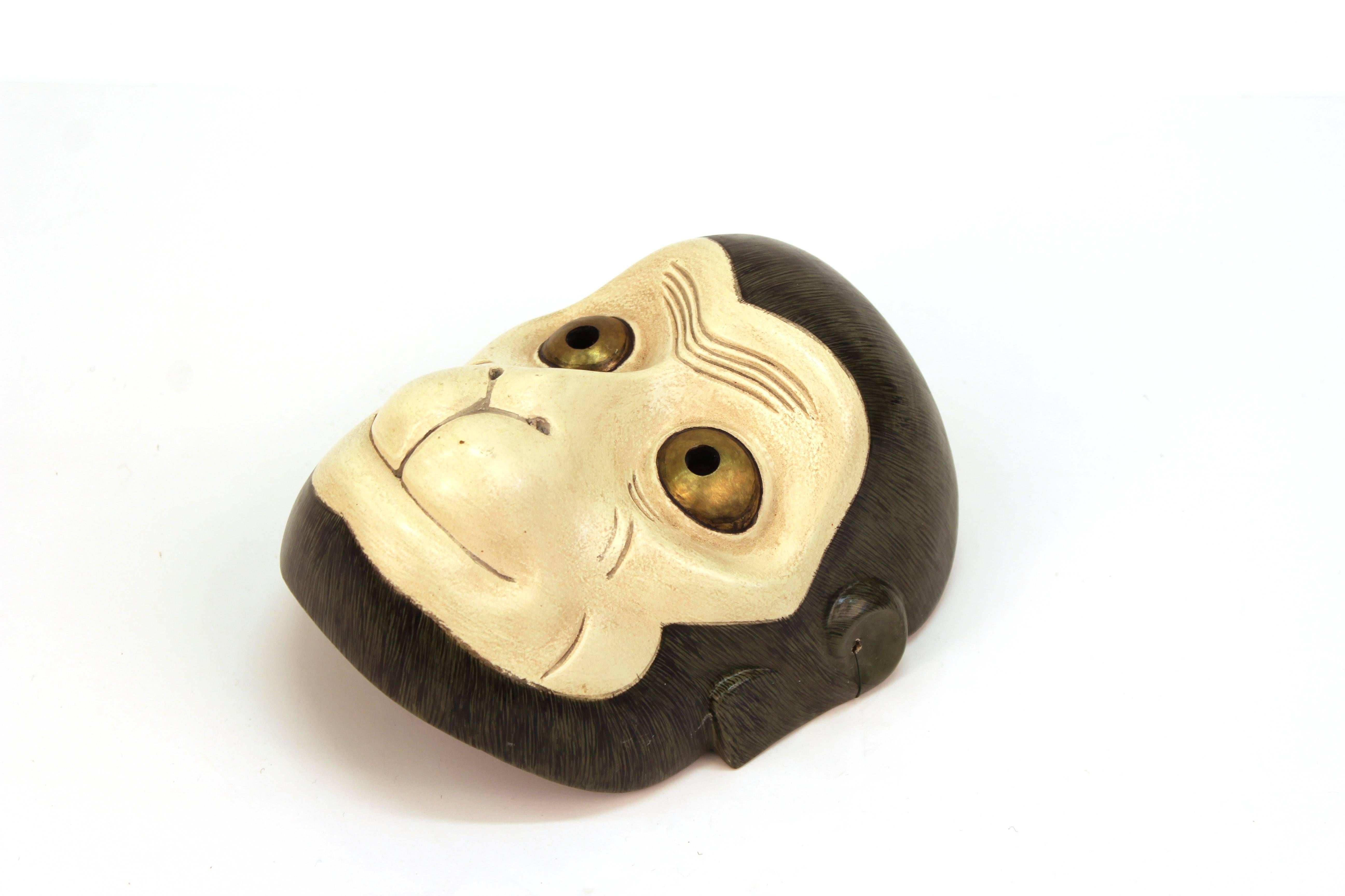 A Japanese sculpted Noh Theater wooden mask depicting Saru the monkey. The piece was sculpted in the Showa Period during the 20th century and is in great vintage condition.