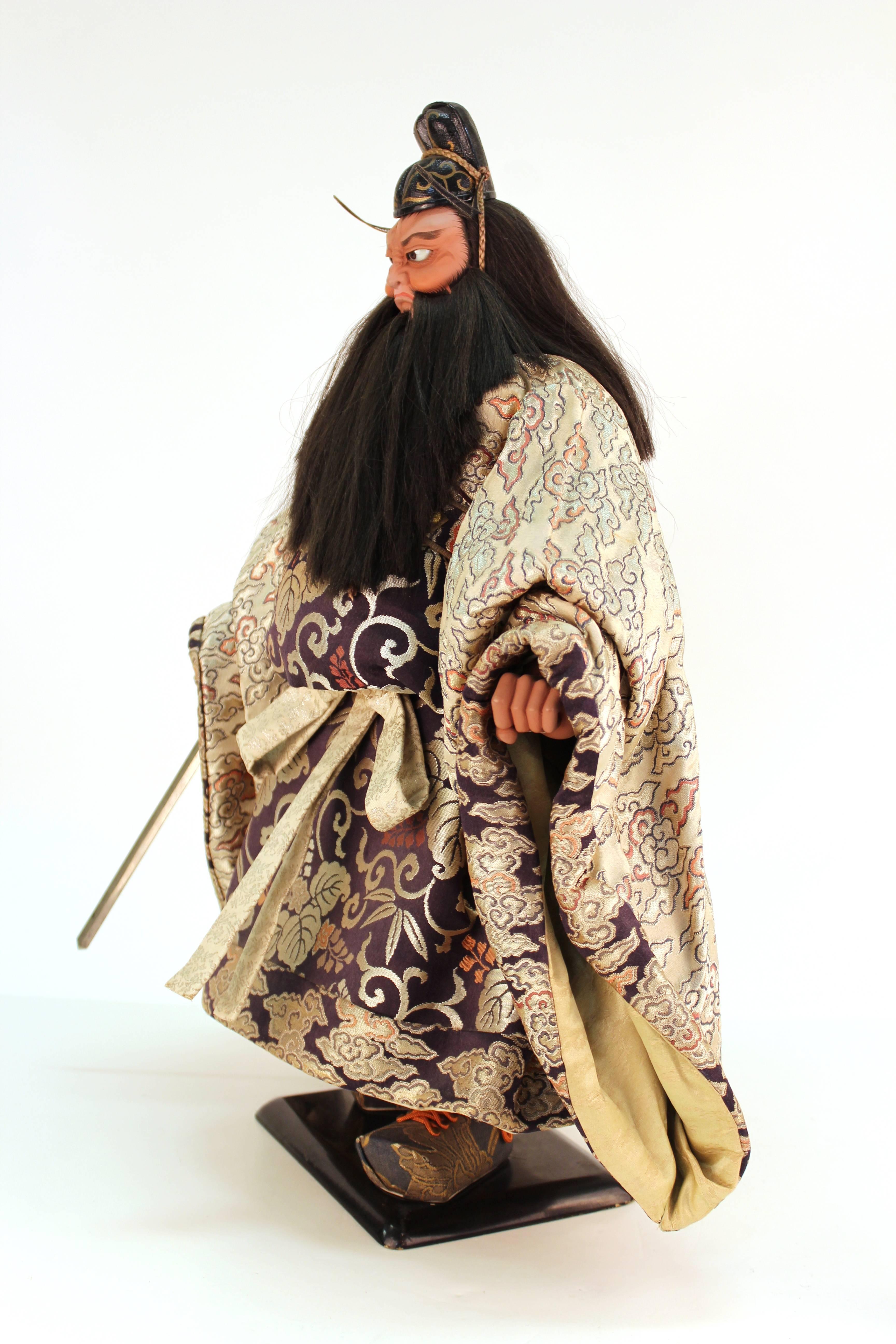 A highly detailed Japanese Musha Ningyo of Shoki, made by Beisyu during the Showa Period, circa 1960. Beisyu has cultural properties status (Mukei Bukazai). He has silk hair, glass eyes, gofun face and hands and sumptuous silk brocade. In great