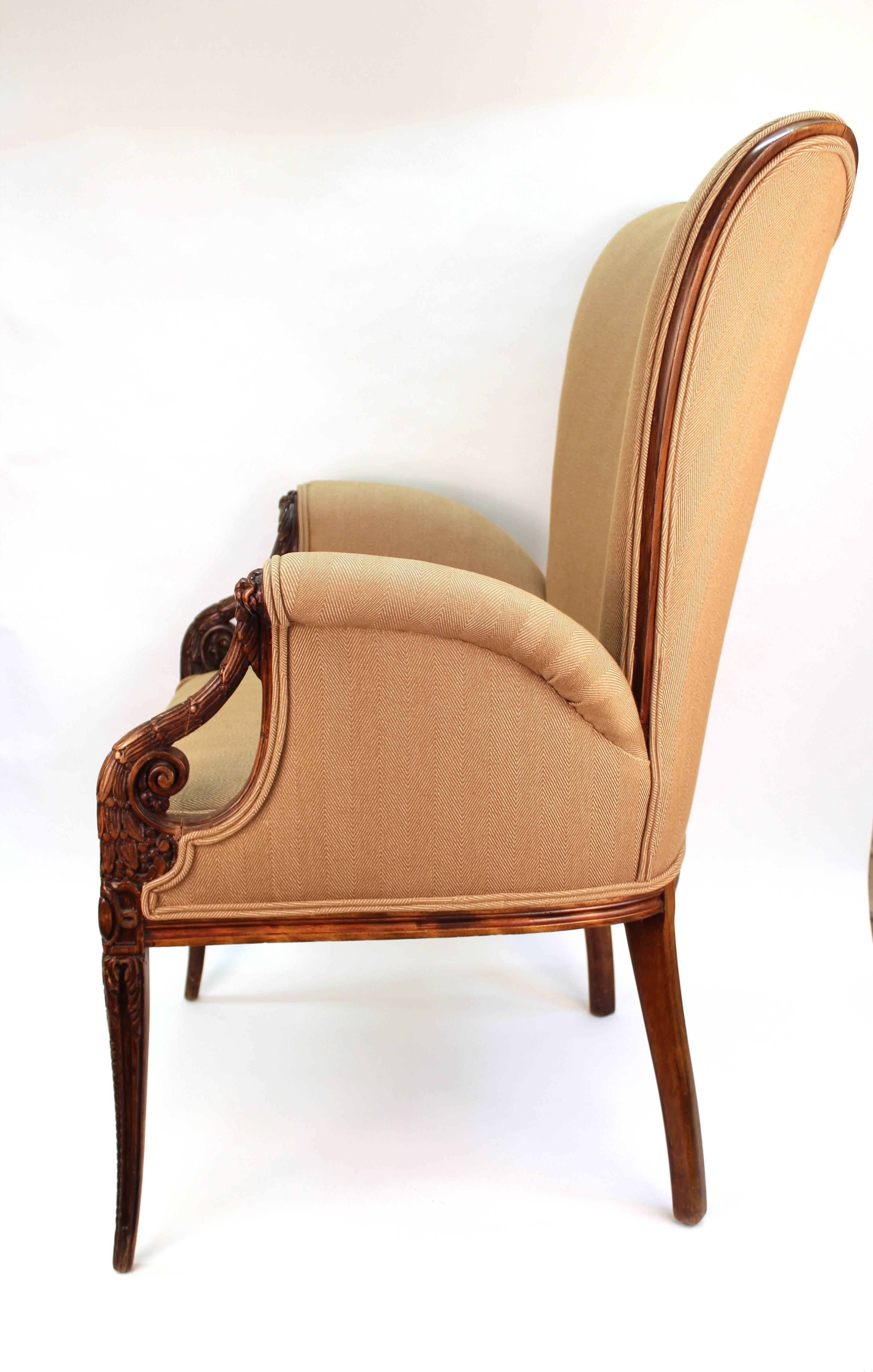 A pair of butterfly armchairs in neoclassical style, made in the 1940s by Grosfeld House with a hand-sculpted wooden structure with rich detailing. In great vintage condition, recently reupholstered.