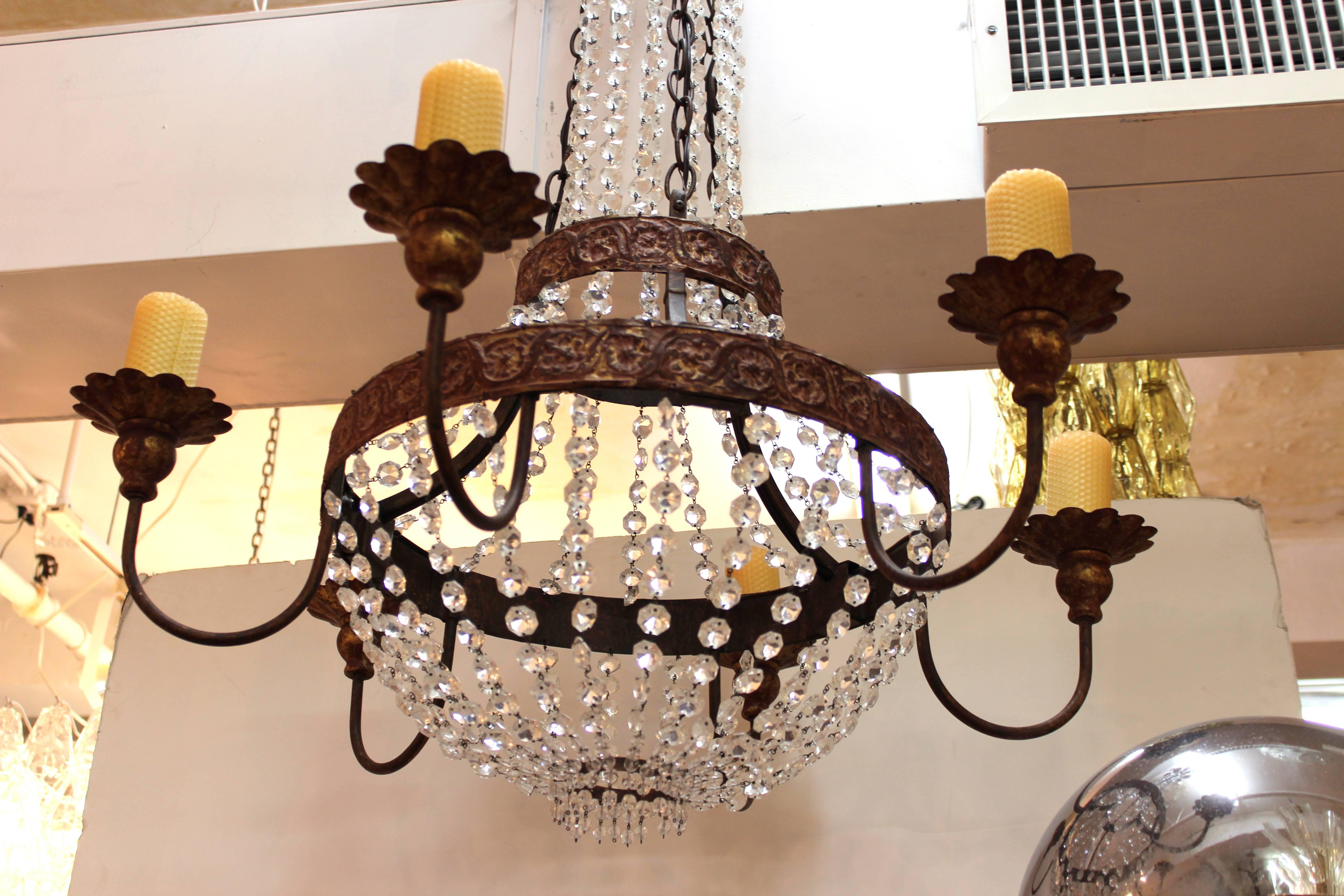 Chandelier in the French 19th Century style. Strings of cut crystal beads cascade from a acanthus leaf crown. Six curved arms with floral details hold large beeswax 