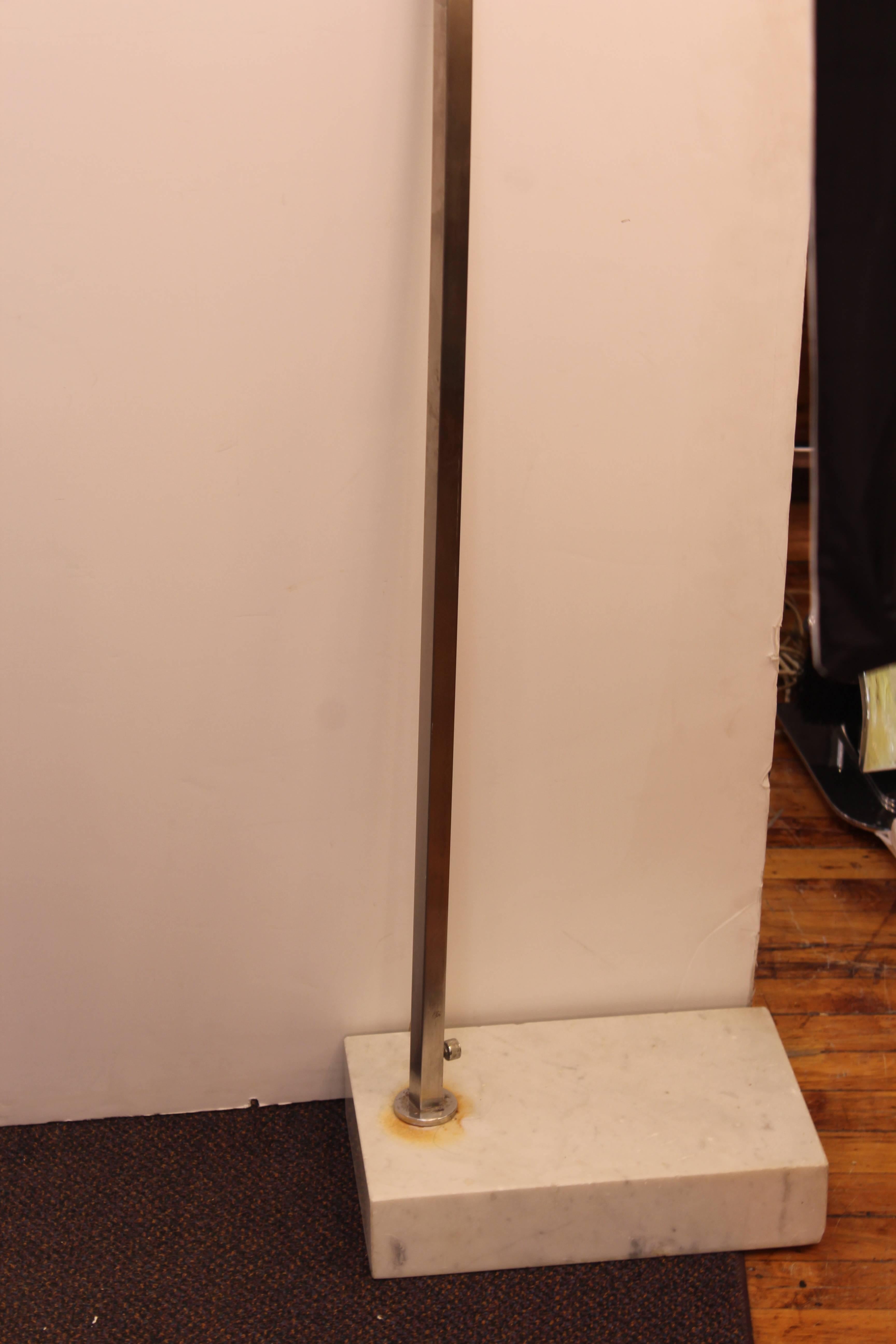 Arc floor lamp in chrome with spherical shade. Mounted on a rectangular white marble base. Wear appropriate to age and use. The piece is in good condition.

Base Dimensions: 3