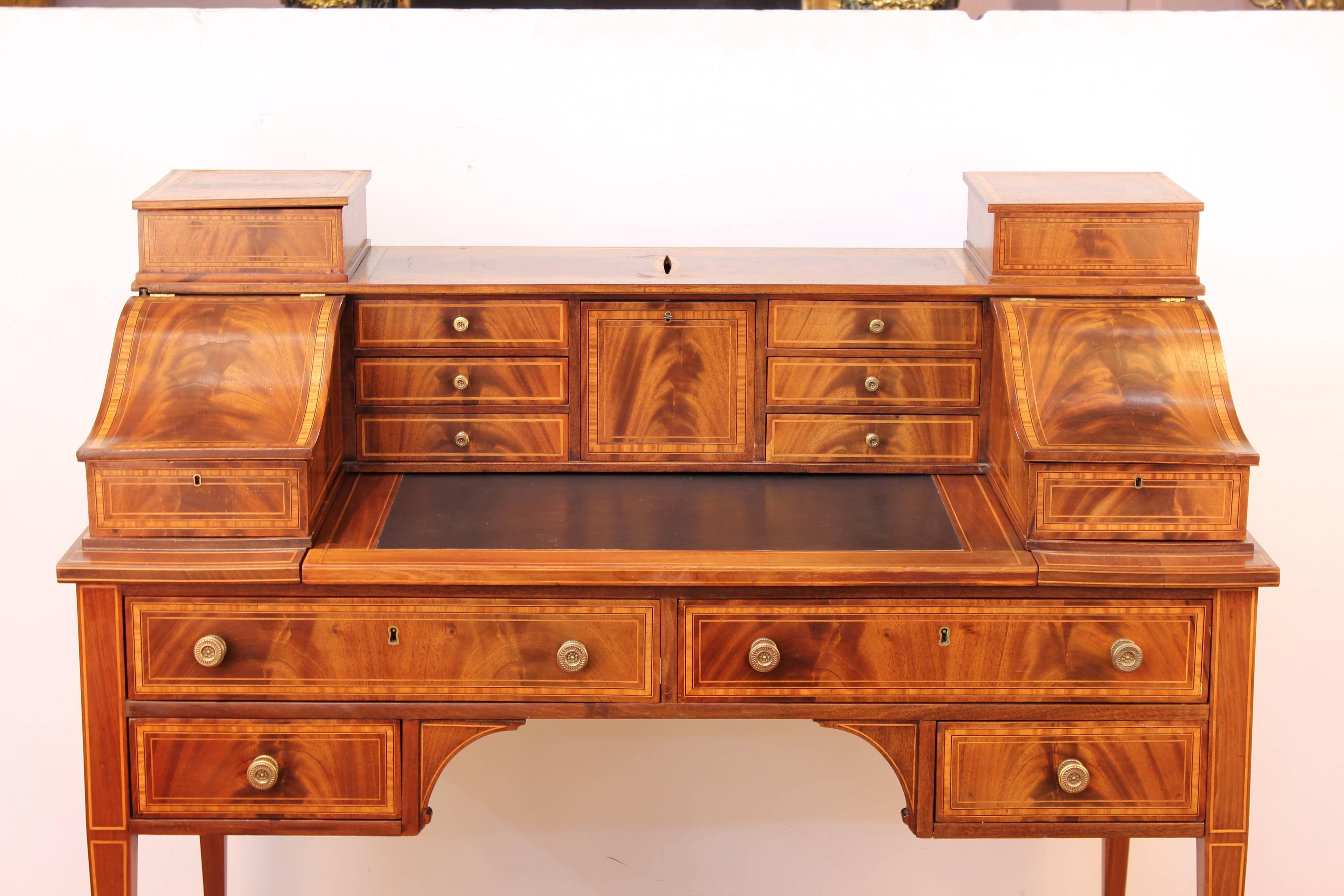 Carlton House desk dating from the 19th Century. Stands on four narrow carved legs and accented in delicate wood work. Features multiple drawers, compartments and a top extension. Wear appropriate to age and use. The piece is in good condition. 